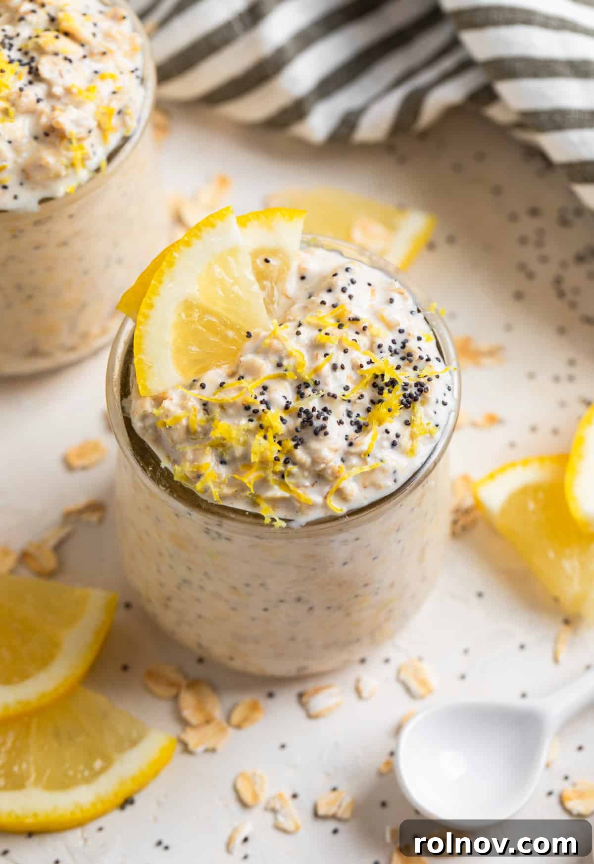 Sunshine Lemon Poppy Seed Overnight Oats 2 A glass jar filled with creamy lemon poppy seed overnight oats, topped with fresh lemon zest and poppy seeds, ready for a healthy breakfast.