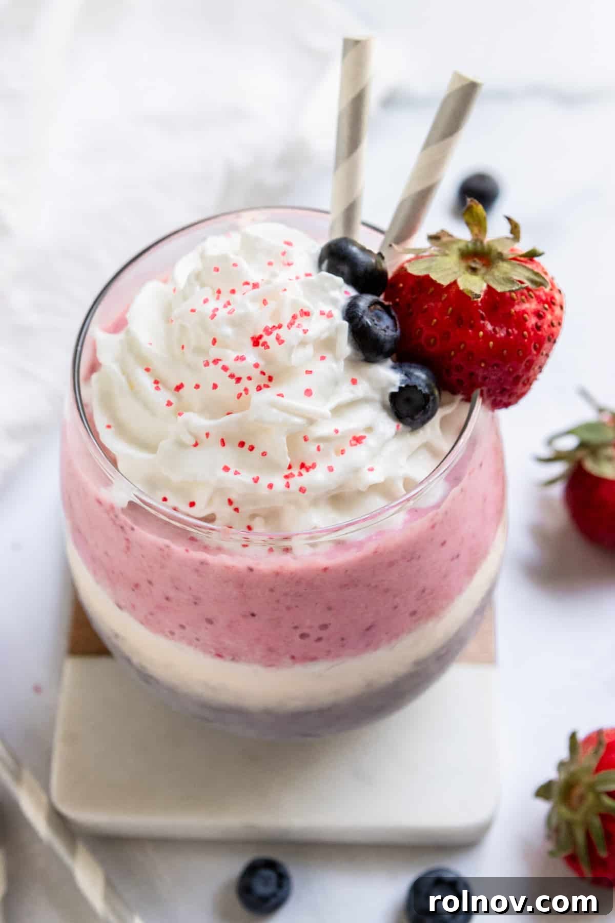 Patriotic Swirl Shake 2 Red white and blue milkshake with whipped cream and fruit.