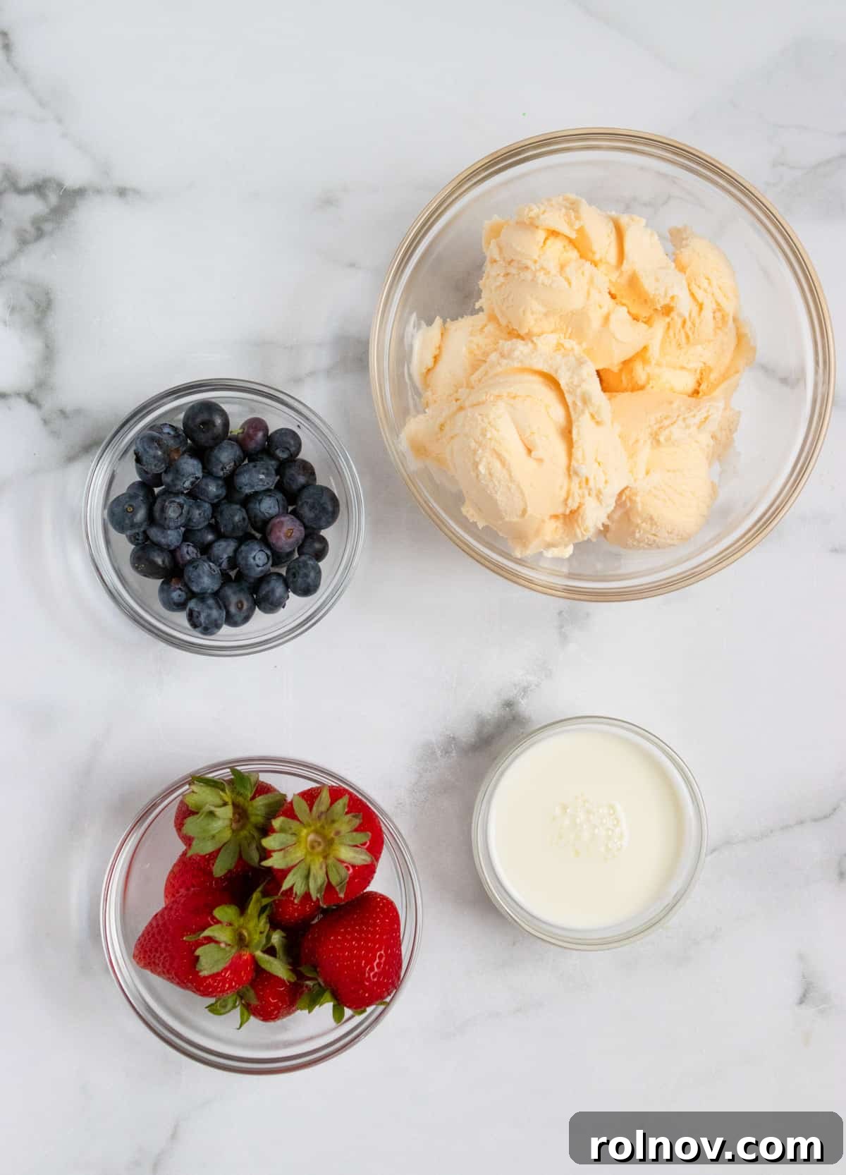 Patriotic Swirl Shake 3 vanilla ice cream, milk and berries on counter.