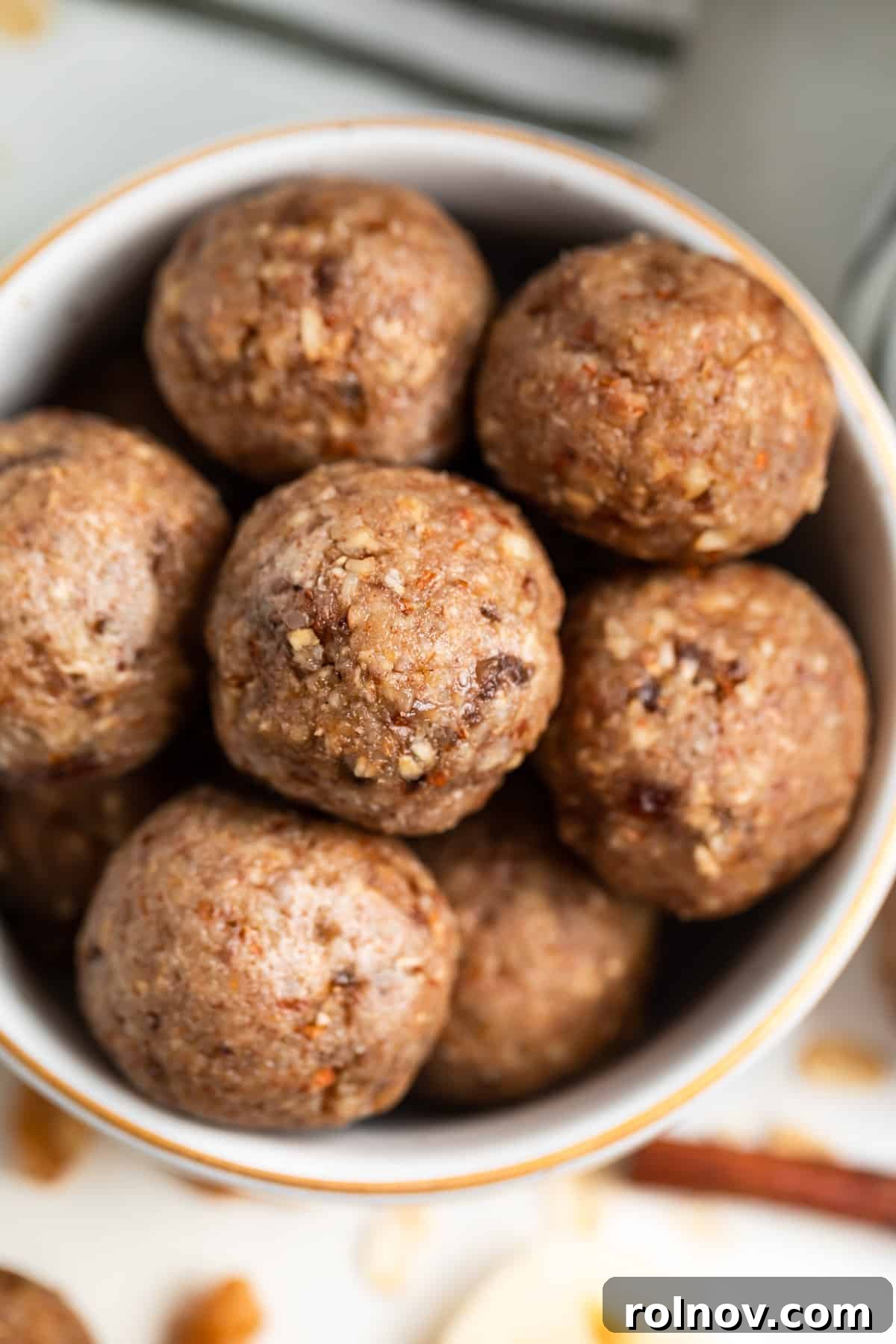 No bake banana oat bites in bowl with gold trim.