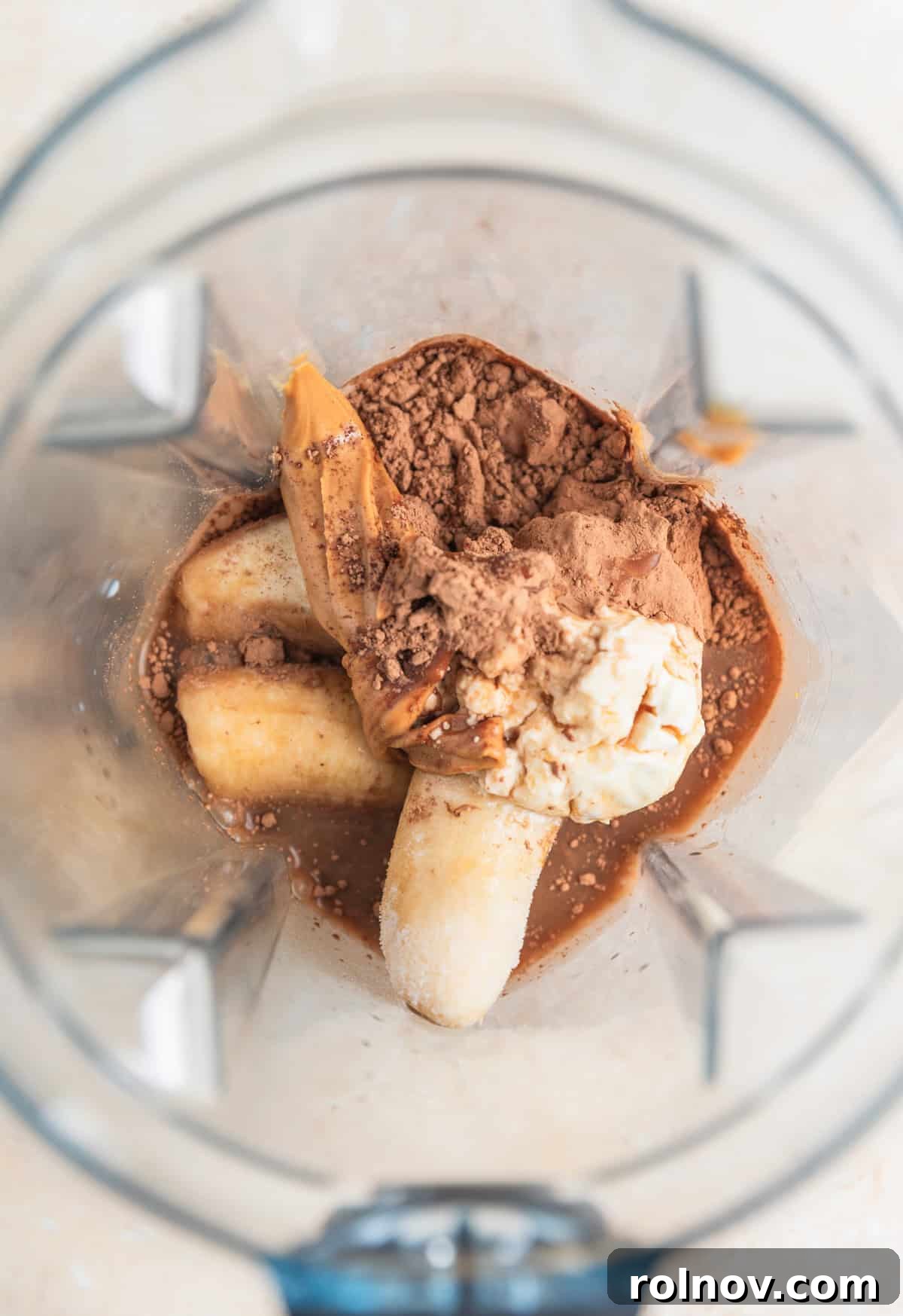 Frozen bananas, cocoa powder, yogurt, peanut butter and coffee in blender.