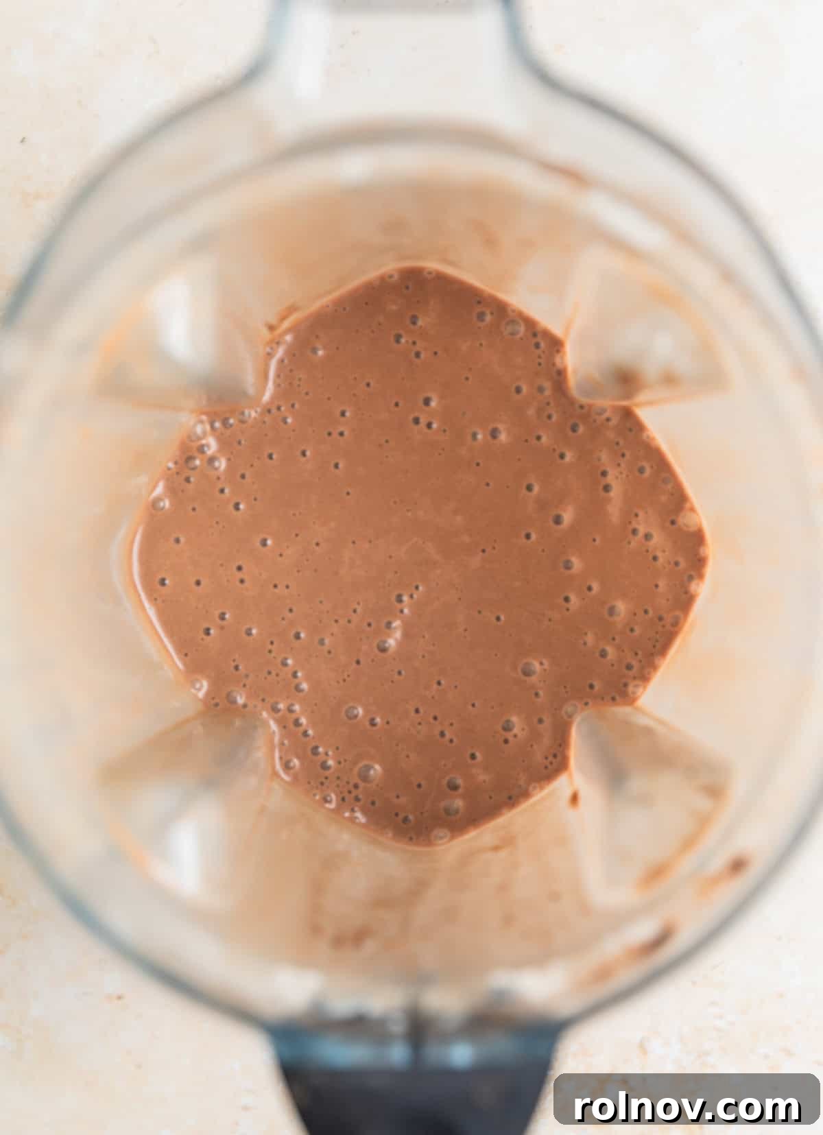 Blender containing peanut butter coffee smoothie.