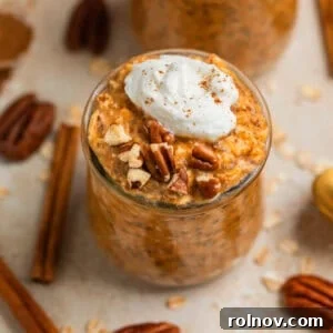 Spiced Pumpkin Overnight Oats 5 Pumpkin pie overnight oats in jar topped with whipped cream and cinnamon and pecans.