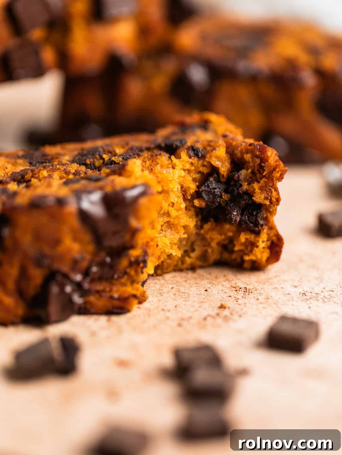 Pumpkin Speckled Banana Bread 3 Slice of pumpkin chip banana bread with bite taken out of it.