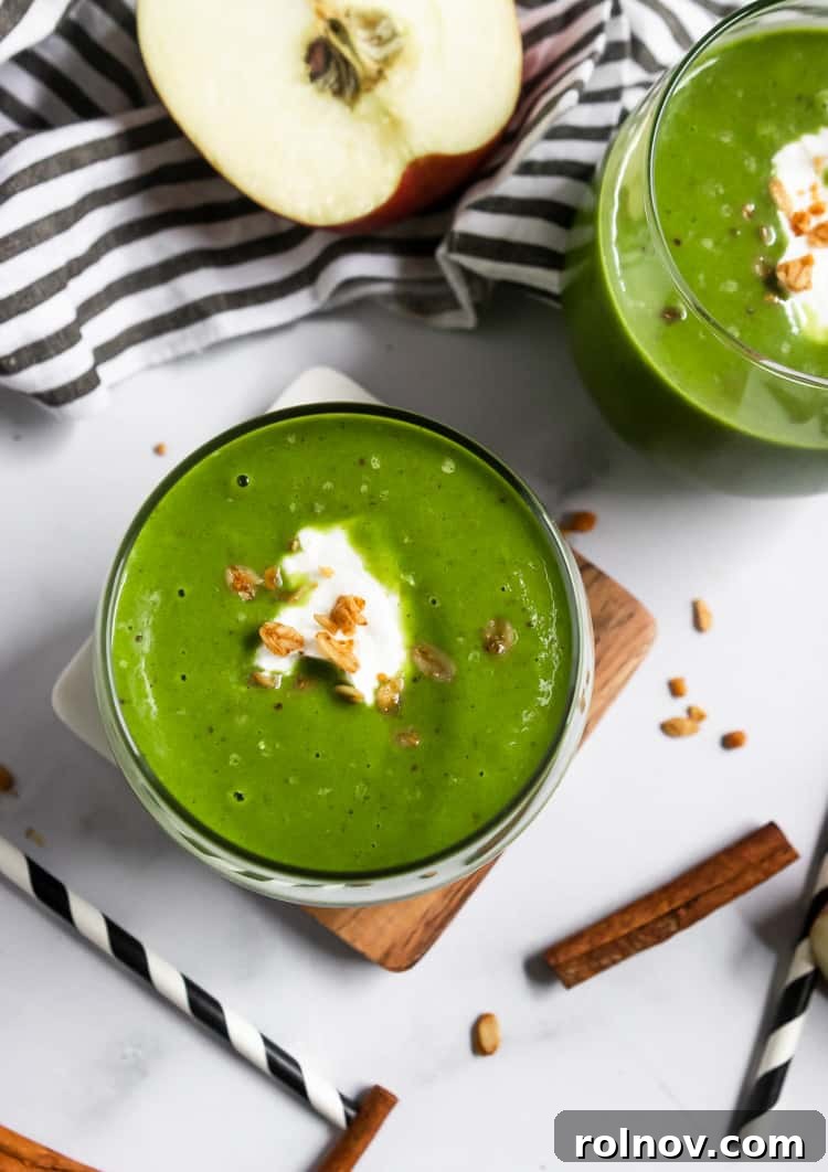 Green Dream Apple Pie Smoothie 5 A beautifully presented green apple smoothie topped with a dollop of yogurt and a sprinkle of granola, suggesting a satisfying breakfast or snack.