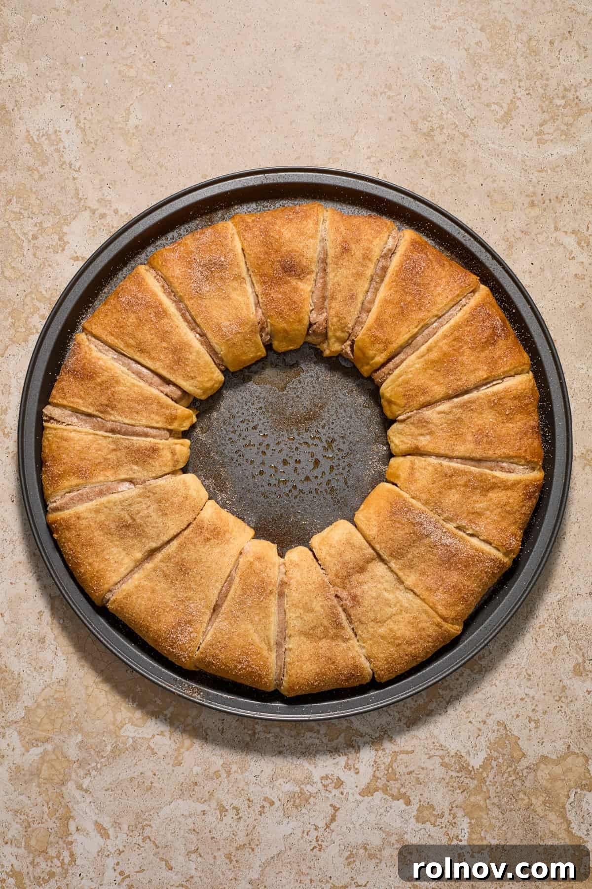 Baked crescent roll wreath on pan.
