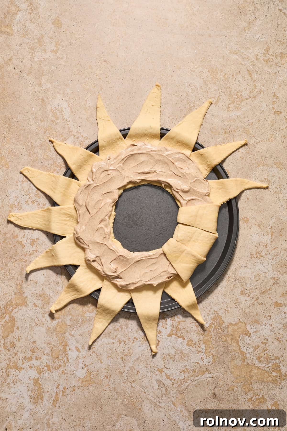 Cinnamon cream cheese mixture spread evenly and then several pieces of dough folded over the top.