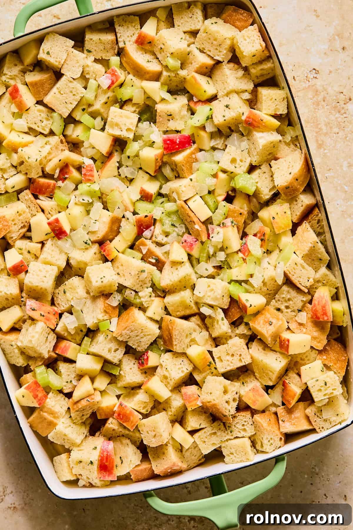 Homestyle Apple Sage Stuffing 10 Apple stuffing mixture transferred to a greased 9x13 inch baking pan, ready for baking.