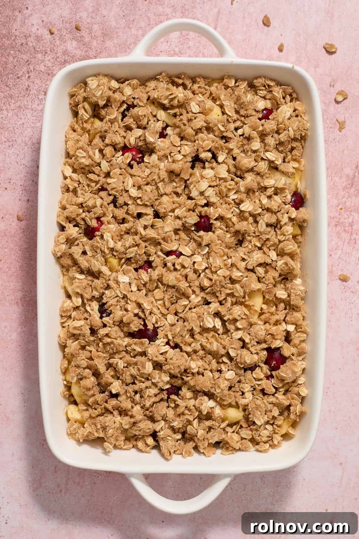 Cranberry apple crisp ingredients in baking pan before baking.