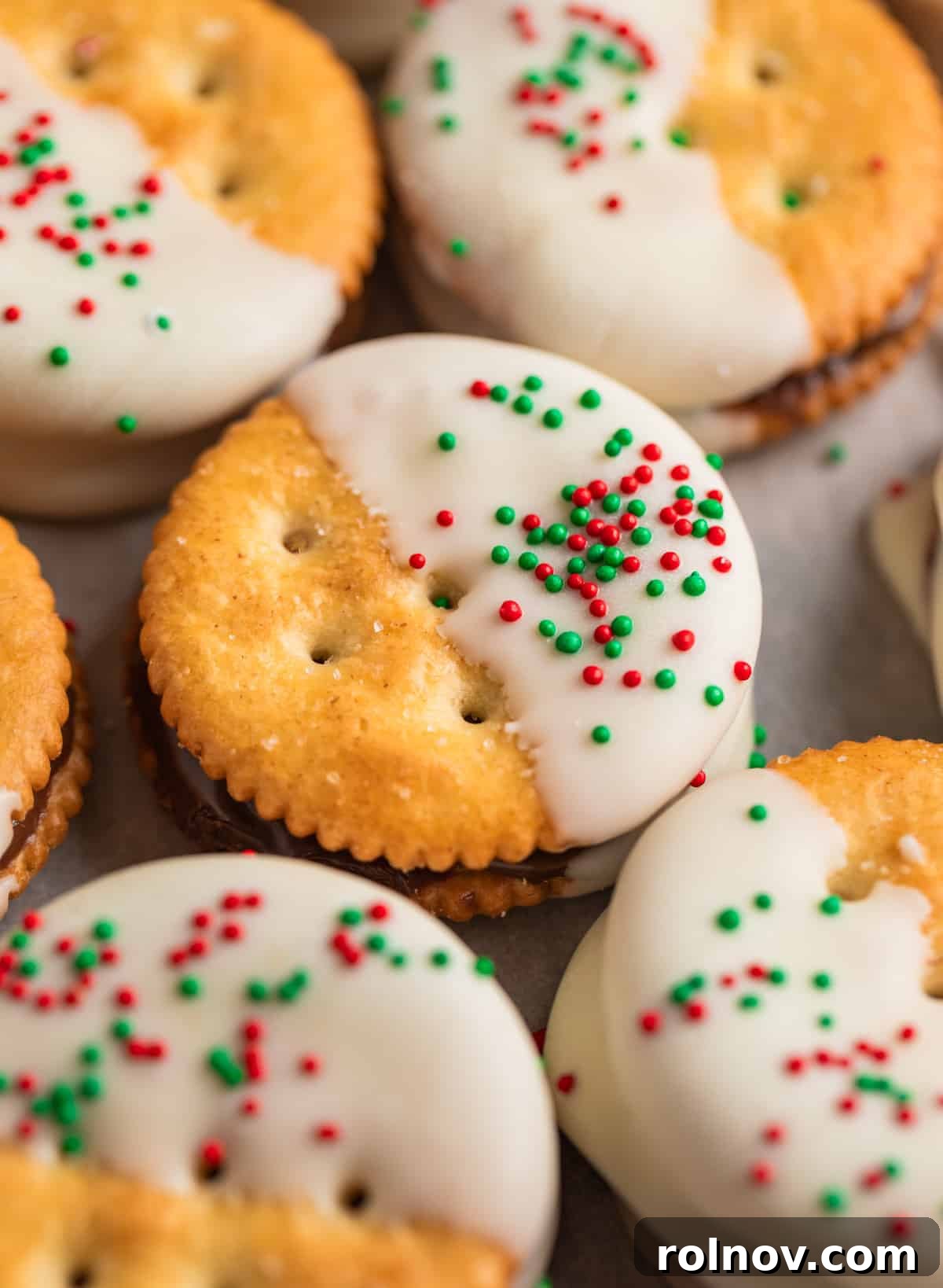 Nutella Ritz cracker cookies dipped in white chocolate arranged on parchment paper.