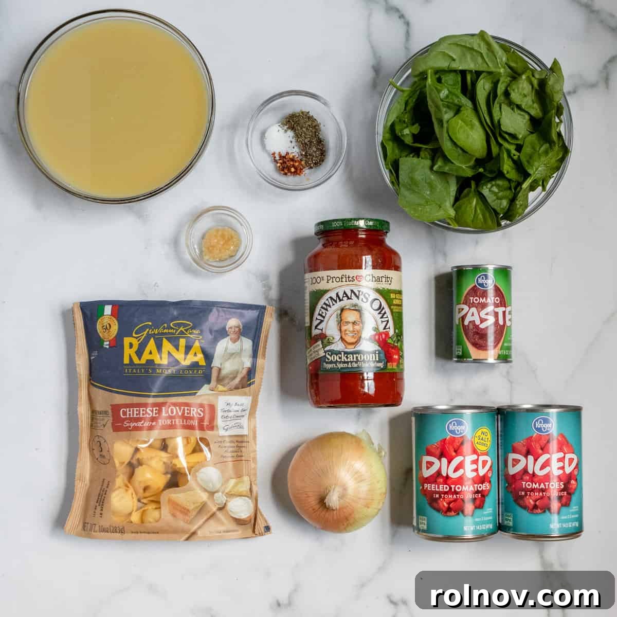 Velvety Tomato Tortellini Soup 3 Ingredients needed to make tomato tortellini soup including broth, spinach, canned tomatoes, and more on coutner.