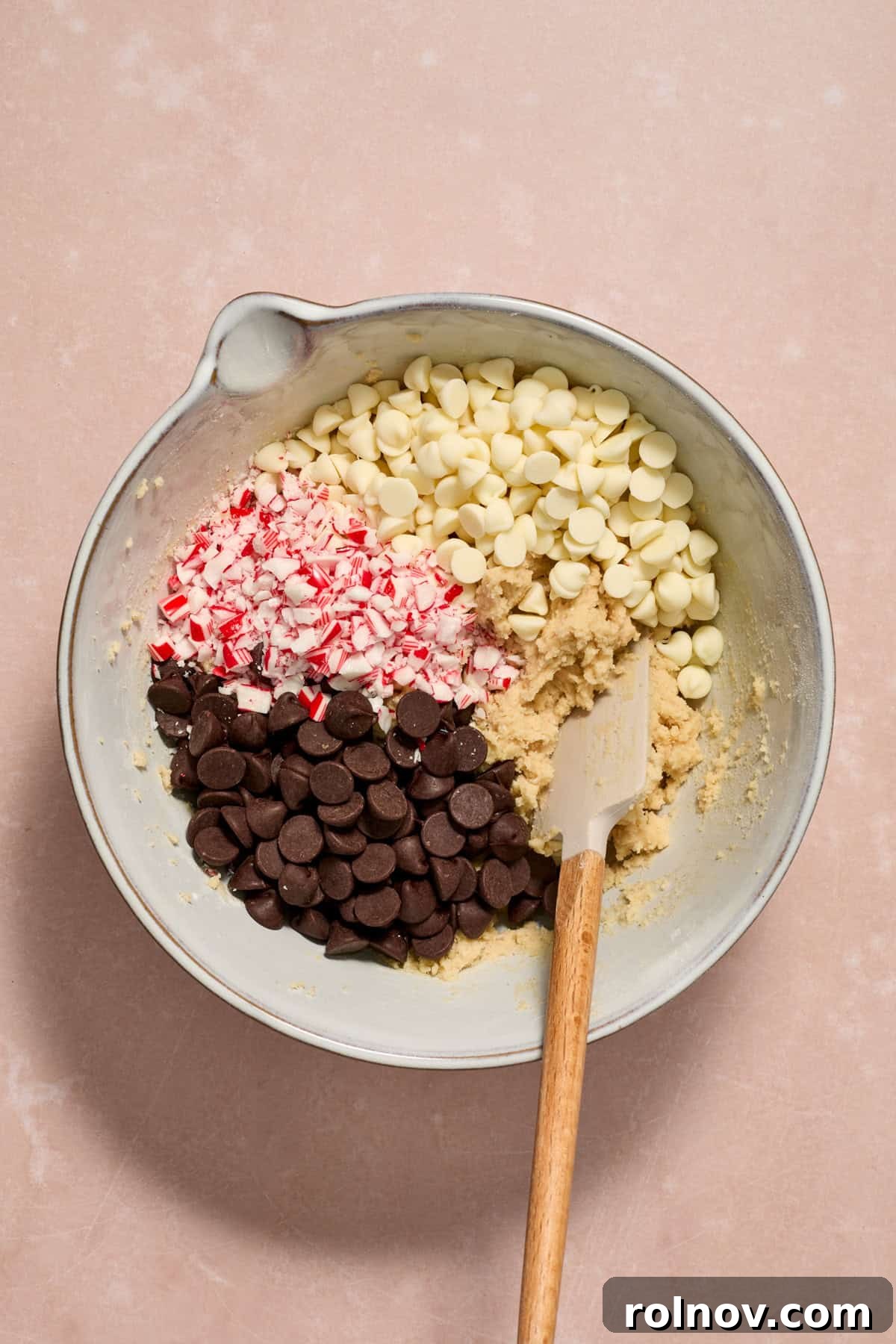 Cool Peppermint Chocolate Chip Cookies 11 White and dark chocolate chips and crushed peppermint candy canes carefully folded into the cookie dough mixture in a bowl.