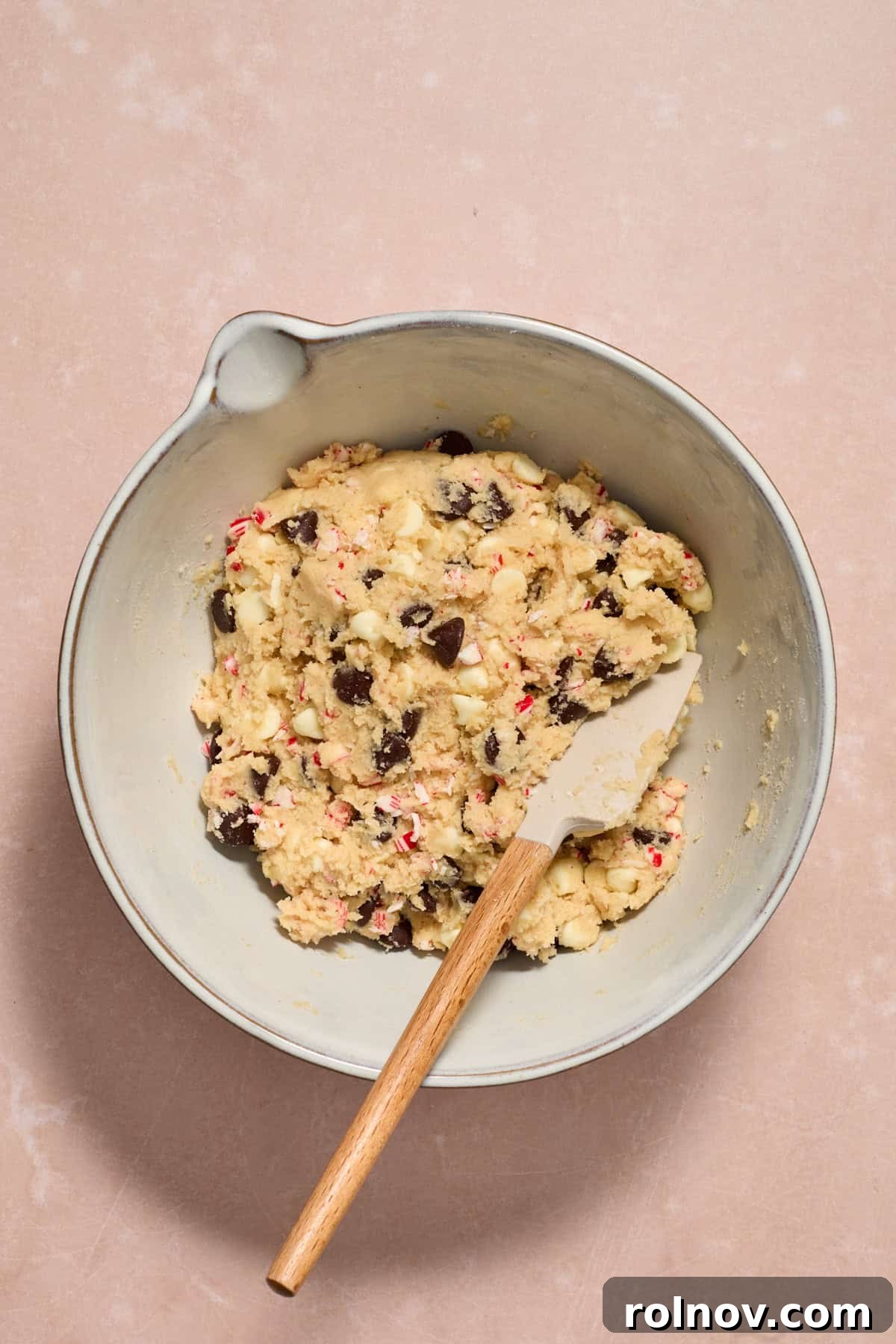Cool Peppermint Chocolate Chip Cookies 12 Prepared chocolate chip peppermint cookie dough resting in a bowl with a spatula, awaiting chilling.