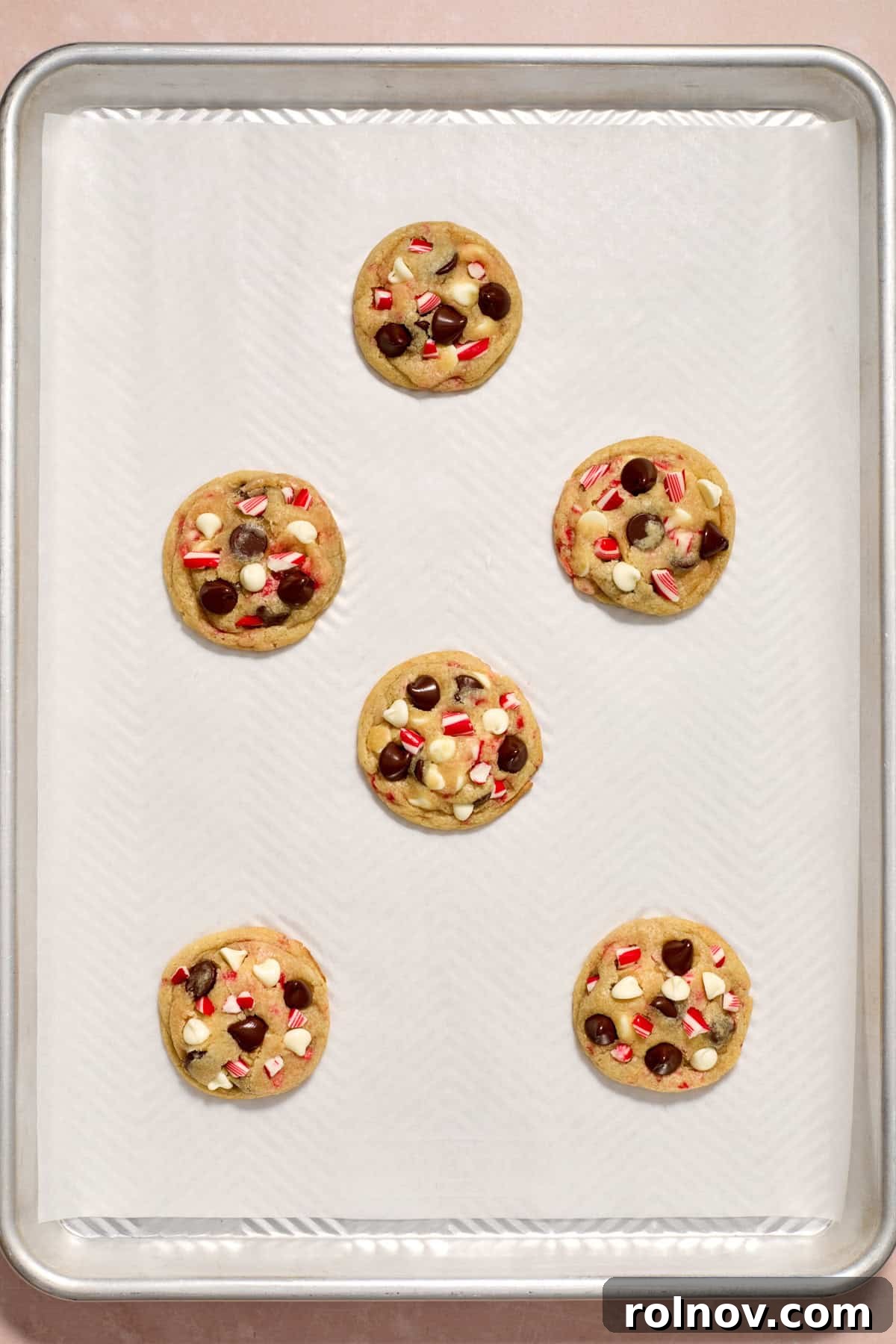 Cool Peppermint Chocolate Chip Cookies 14 Freshly baked peppermint chocolate chip cookies on a baking pan, still warm from the oven.