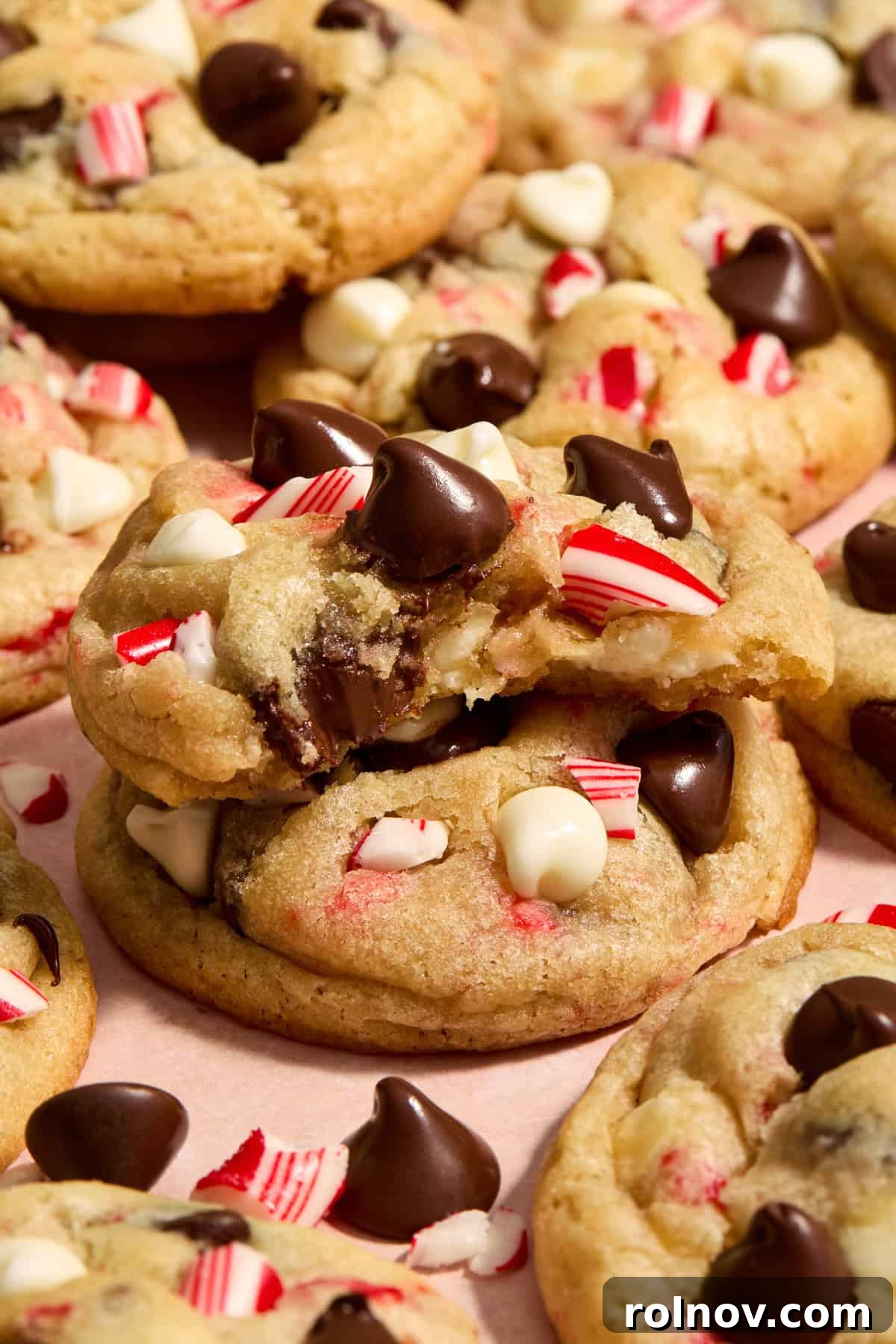 Cool Peppermint Chocolate Chip Cookies 15 A delicious chocolate chip peppermint cookie with a bite taken out, stacked enticingly on another cookie, highlighting its irresistible texture.