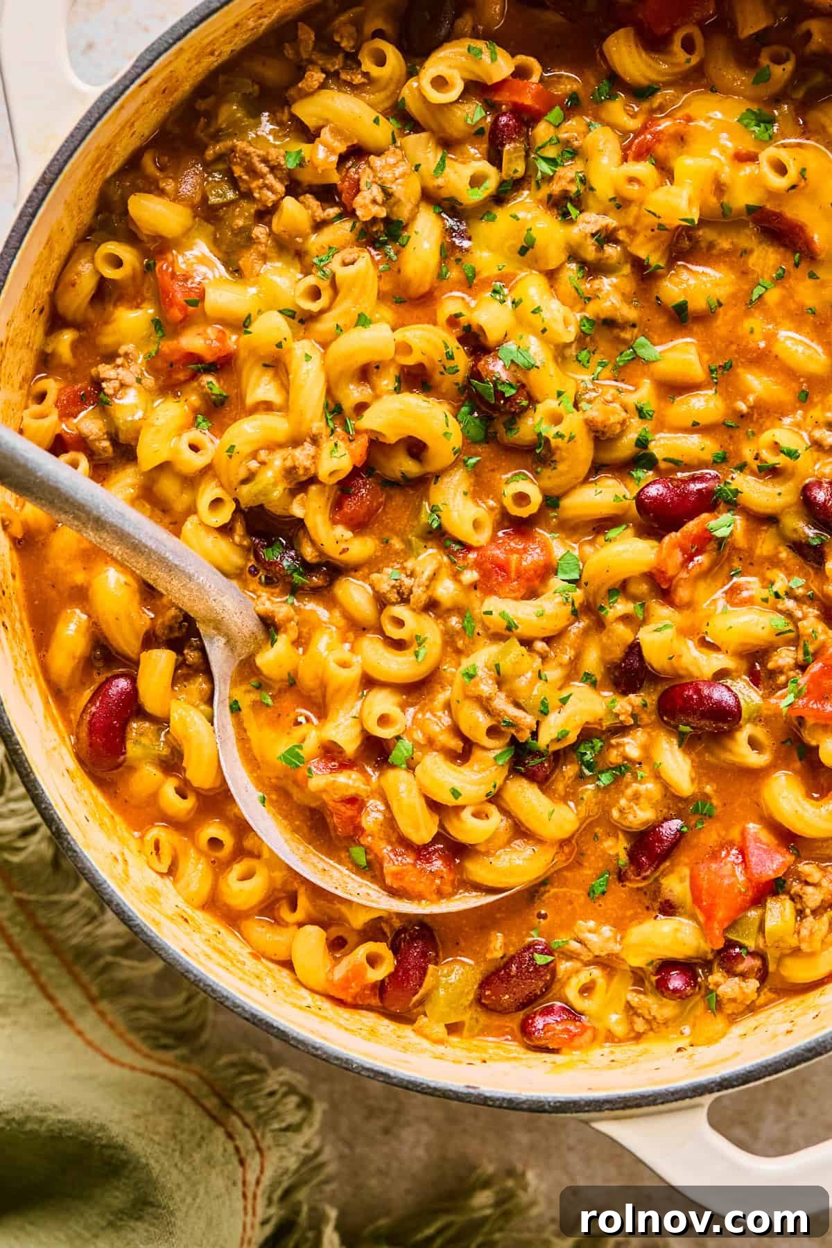 Hearty Skillet Chili Mac 2 A large pot filled with delicious One Pot Chili Mac and Cheese, with a ladle scooping a portion, ready to be served.