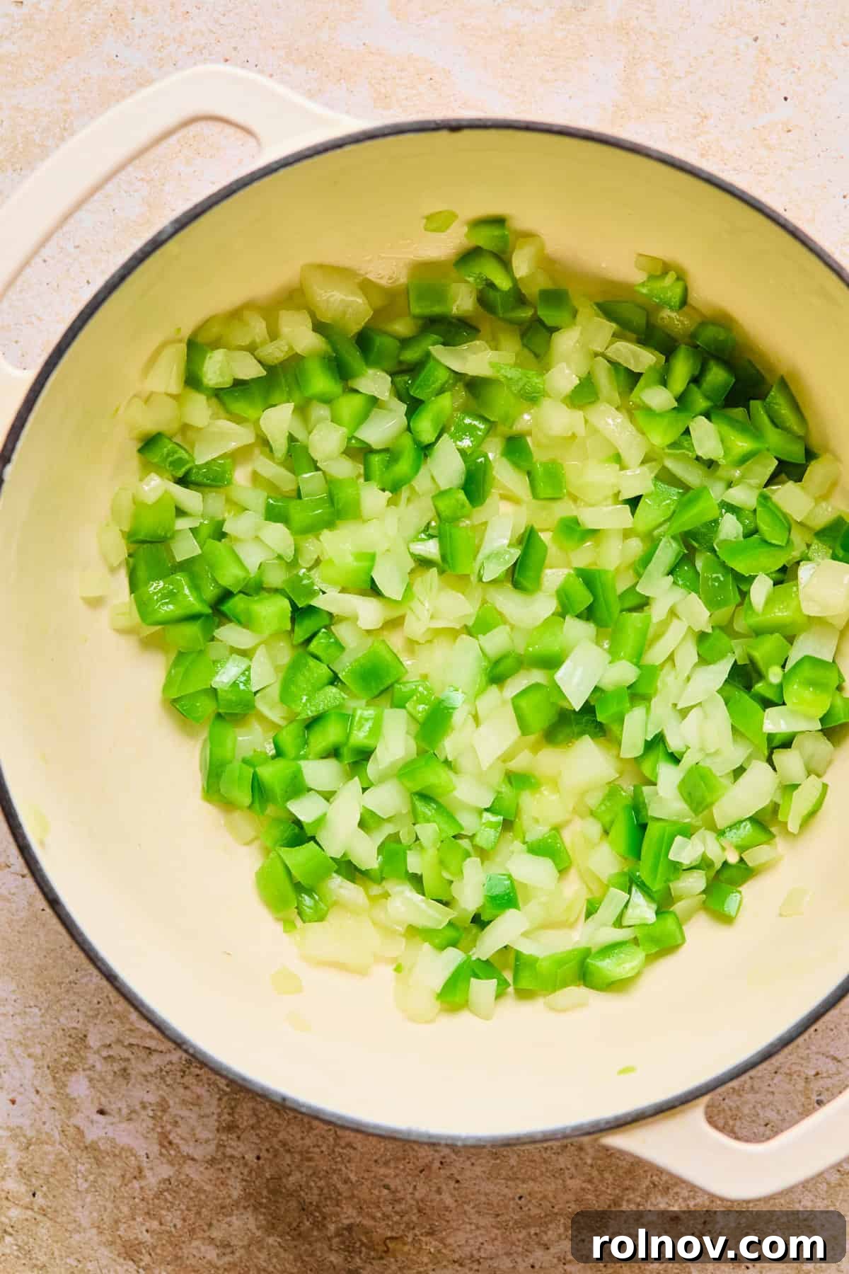 Hearty Skillet Chili Mac 5 Finely chopped onion and green bell pepper sautéing in a large pot with olive oil until softened and translucent.