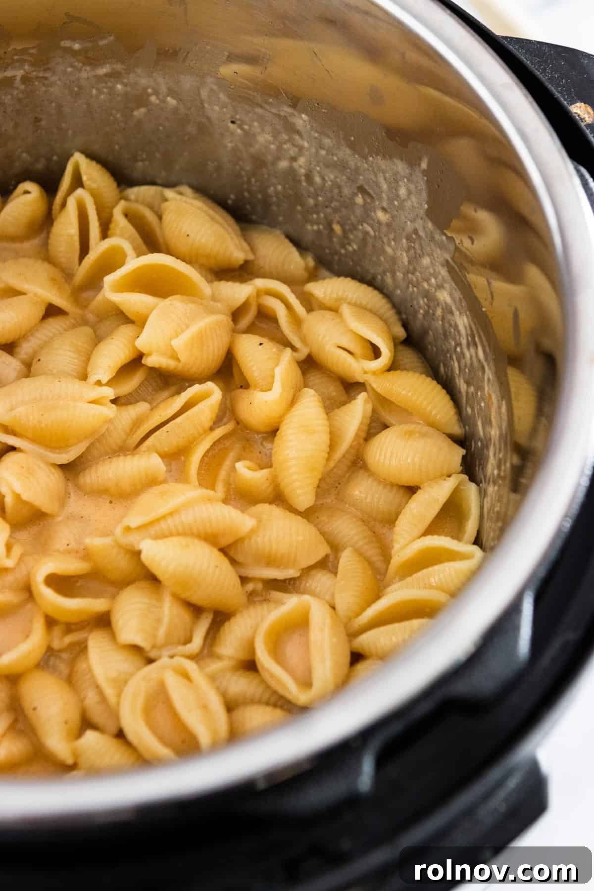 Foolproof Instant Pot Mac and Cheese 5 Close-up shot of rich, creamy macaroni and cheese simmering in the Instant Pot after the cheese and milk have been stirred in.