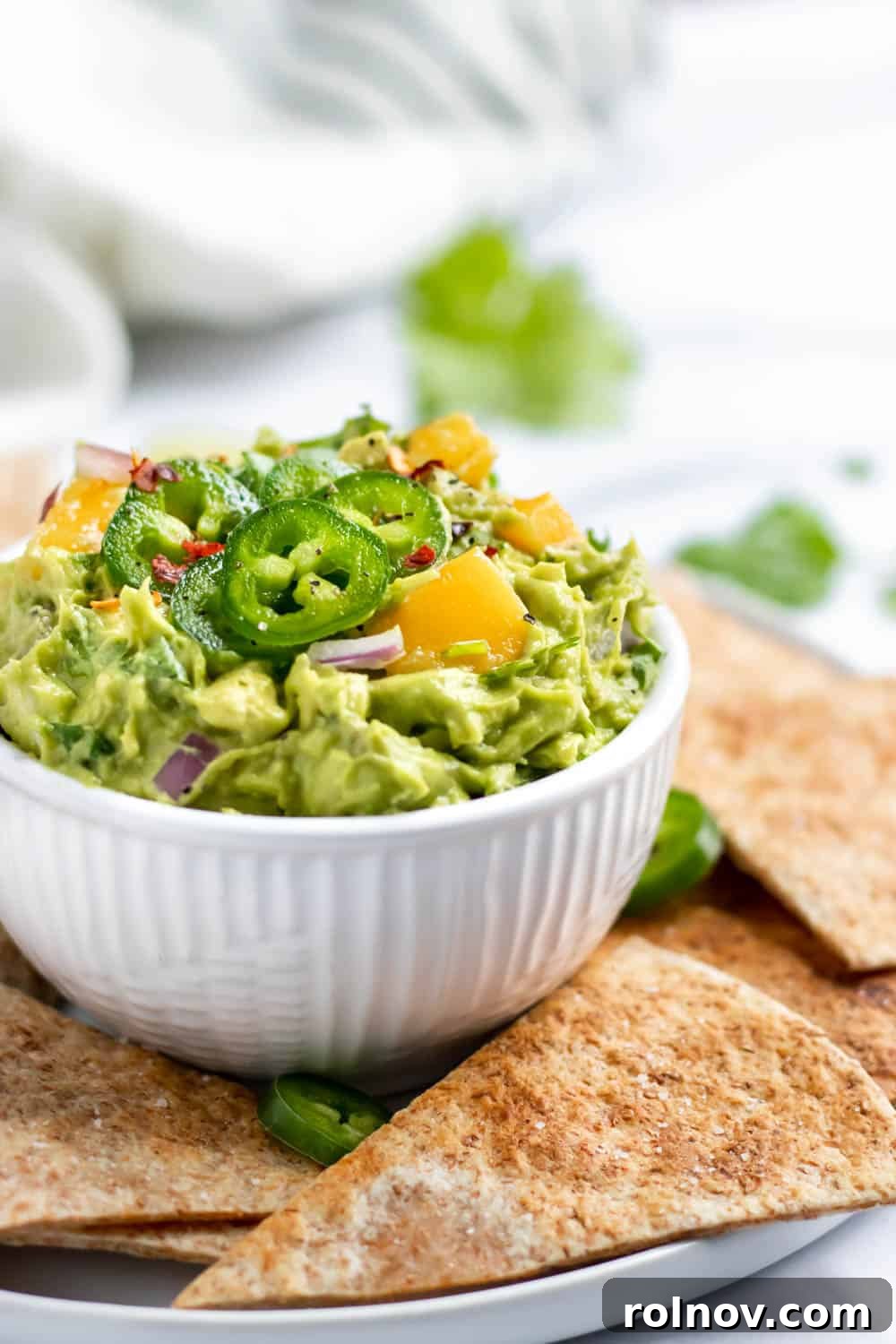 Fiery Mango Guac 3 Close-up of freshly made Spicy Mango Guacamole with chunky avocado and mango pieces