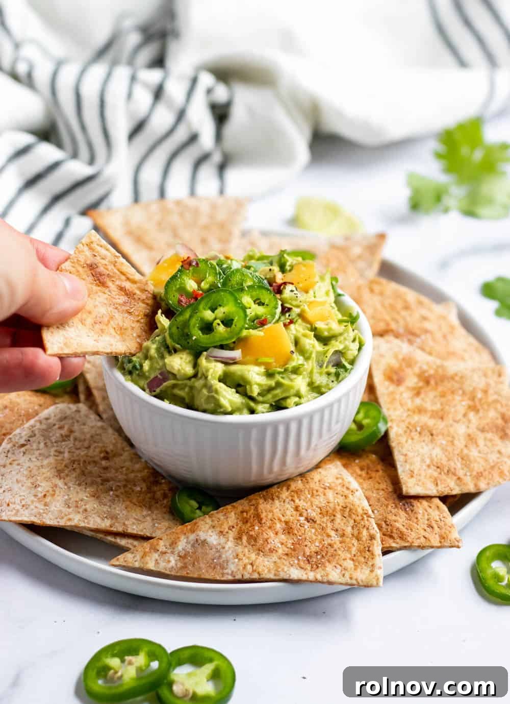 Fiery Mango Guac 4 Overhead shot of a bowl of Spicy Mango Guacamole with tortilla chips on the side