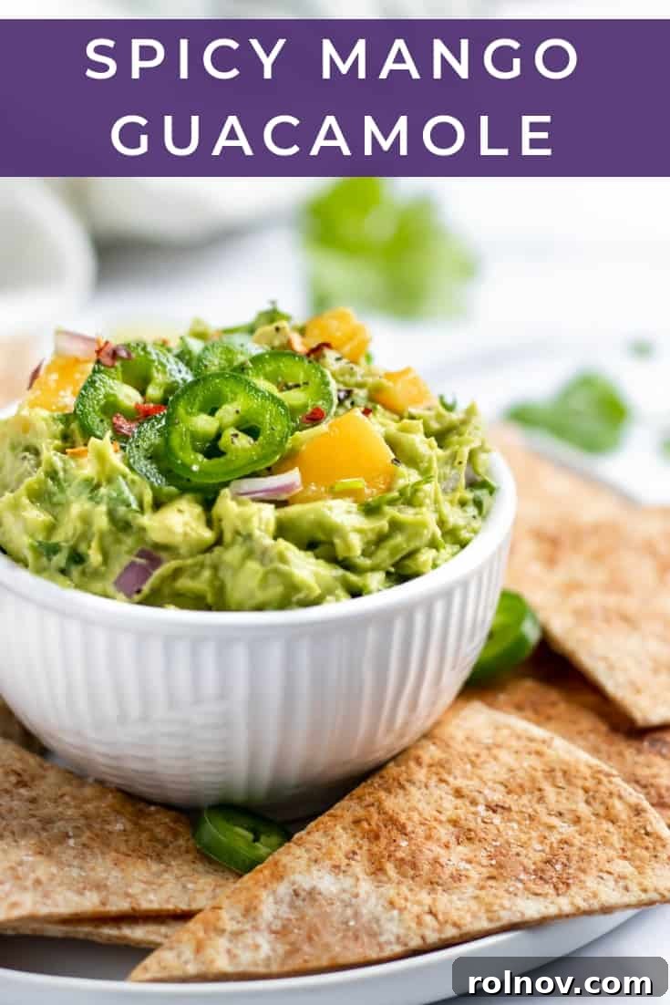 Fiery Mango Guac 6 A bowl of Spicy Mango Guacamole with a variety of colorful tortilla chips and fresh ingredients