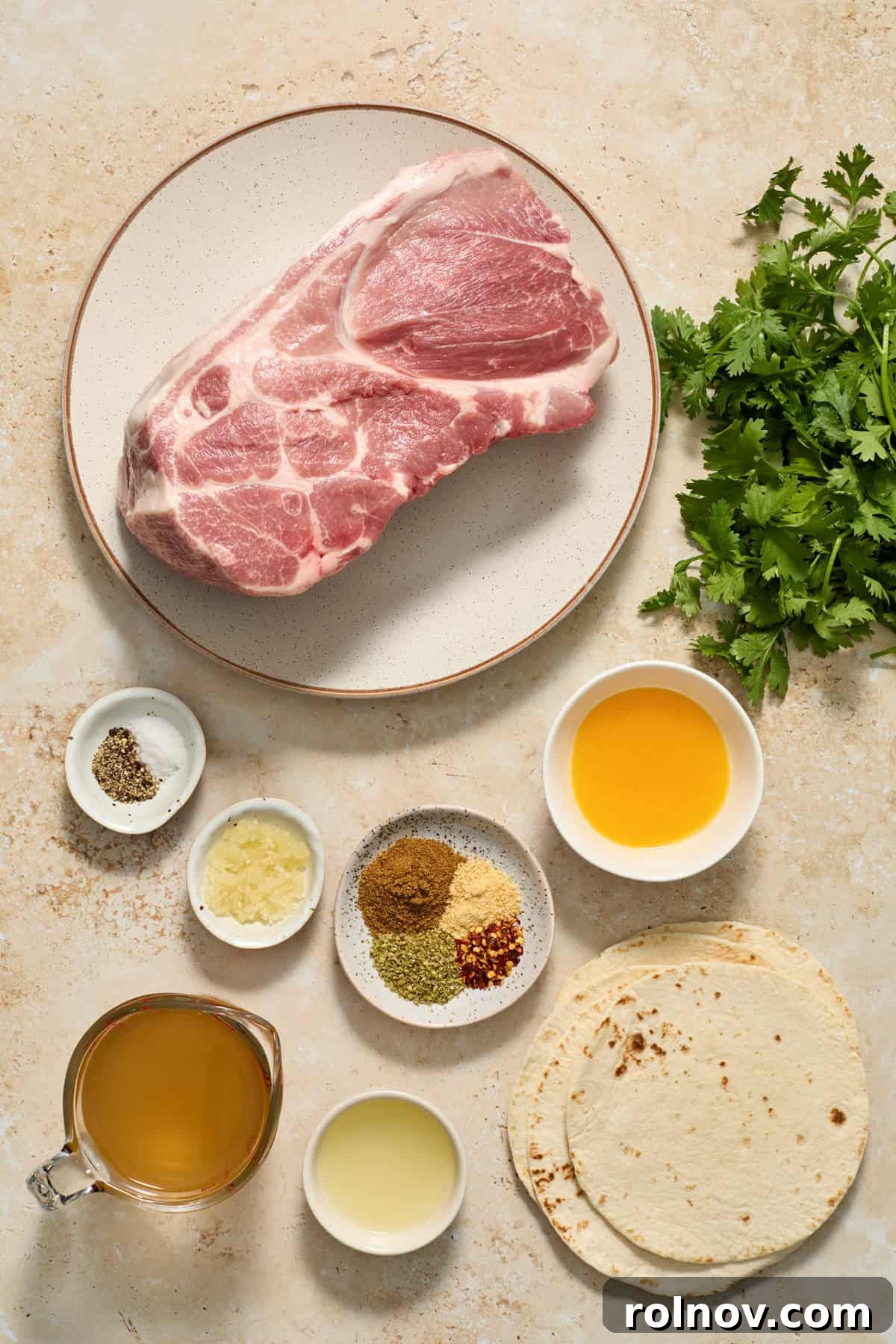 Lightning-Fast Crispy Instant Pot Carnitas 3 Pork shoulder on plate along with tortillas, cilantro, broth, orange juice and other ingredients.