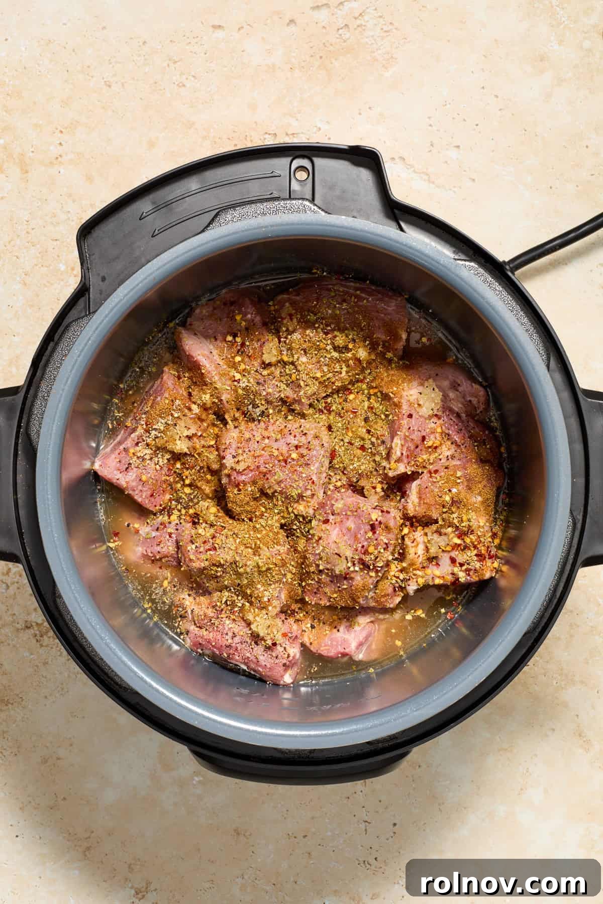 Lightning-Fast Crispy Instant Pot Carnitas 4 Seasoned chunks of pork in Instant Pot before cooking.