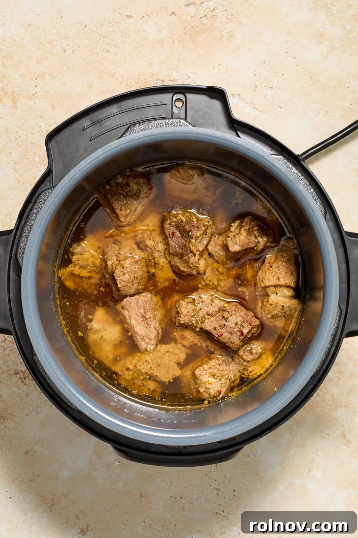 Lightning-Fast Crispy Instant Pot Carnitas 6 Cooked pork carnitas in pot before shredding.