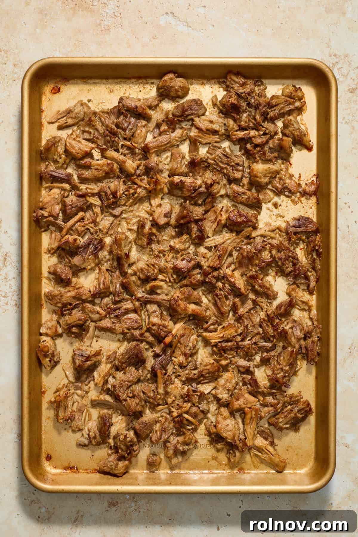 Lightning-Fast Crispy Instant Pot Carnitas 9 Sheet pan with shredded pork after broiling.