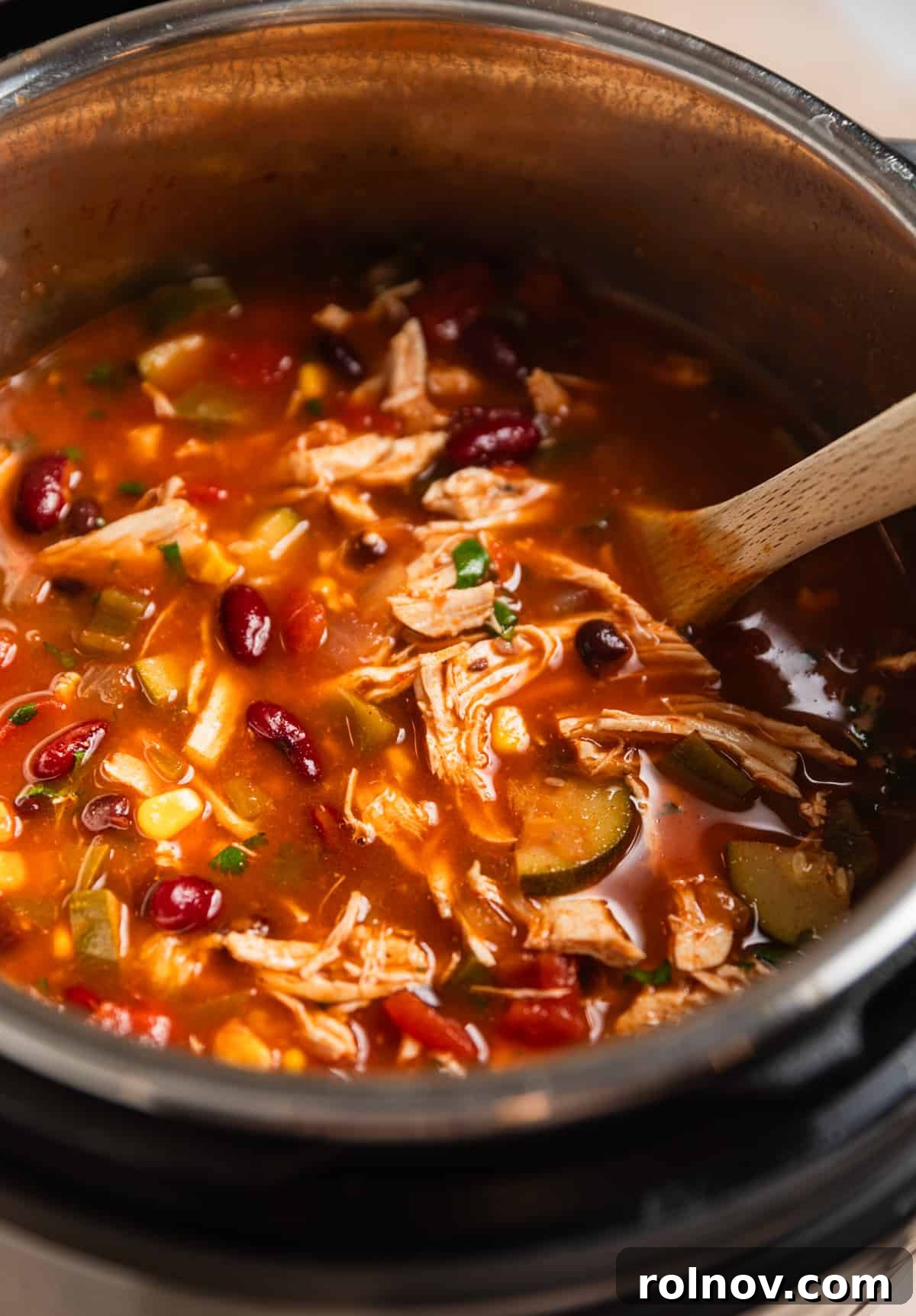 Ultimate Instant Pot Chicken Tortilla Soup 10 Instant pot chicken tortilla soup with wooden spoon.