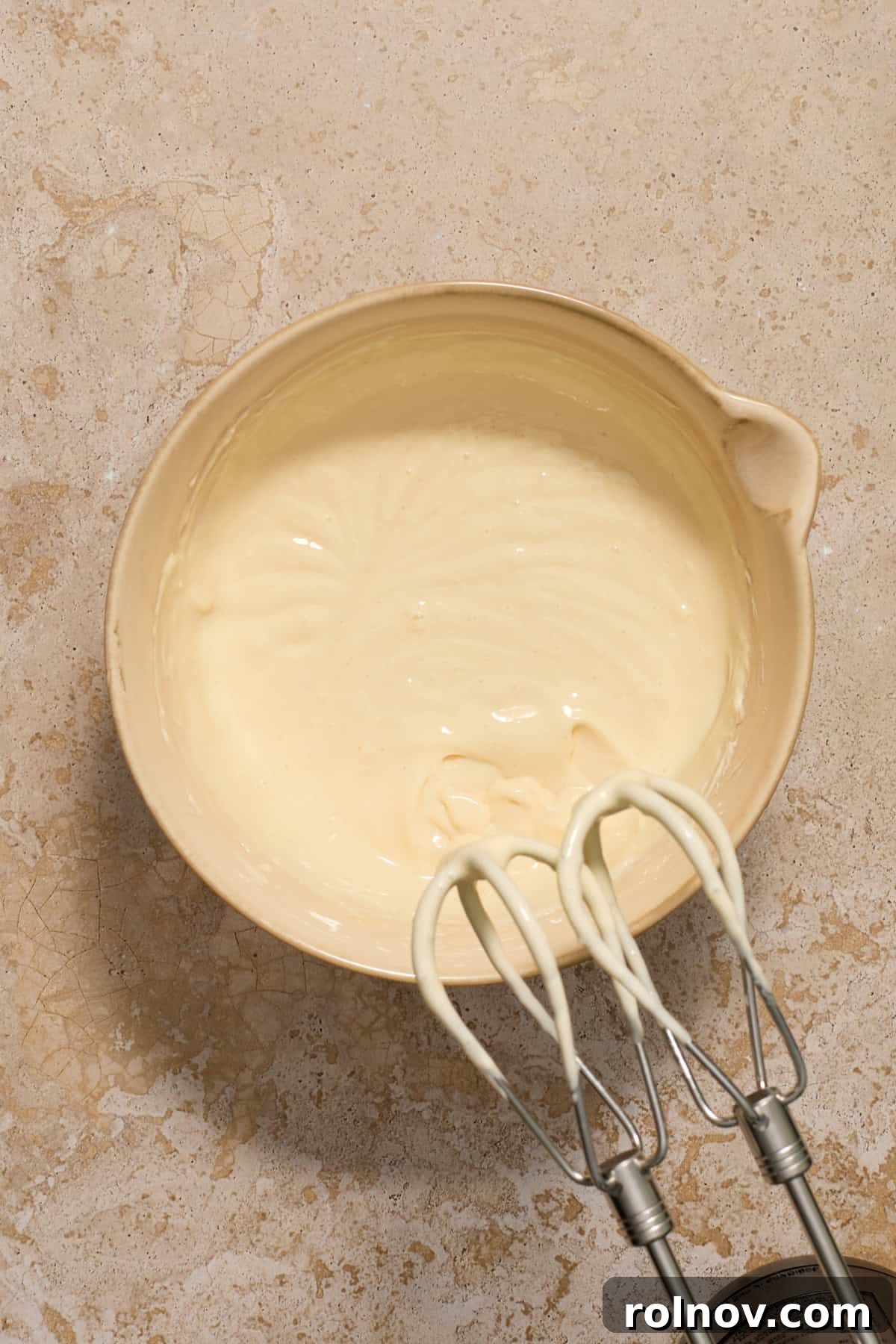 Kahlua Swirled Cream Cheese Brownie Bliss 7 Smooth and creamy cheesecake mixture in a mixing bowl after the egg and vanilla have been fully incorporated with an electric mixer.