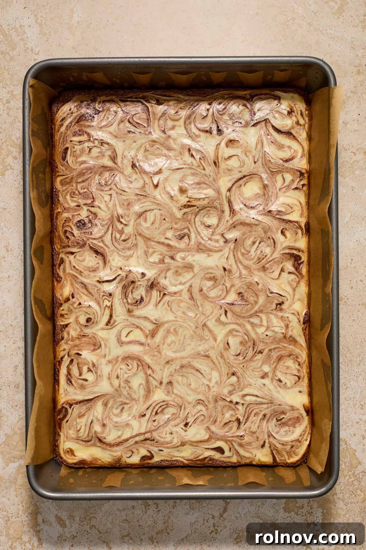 Kahlua Swirled Cream Cheese Brownie Bliss 10 Freshly baked Kahlua Cream Cheese Brownies with visible swirls in a baking pan, golden and set.
