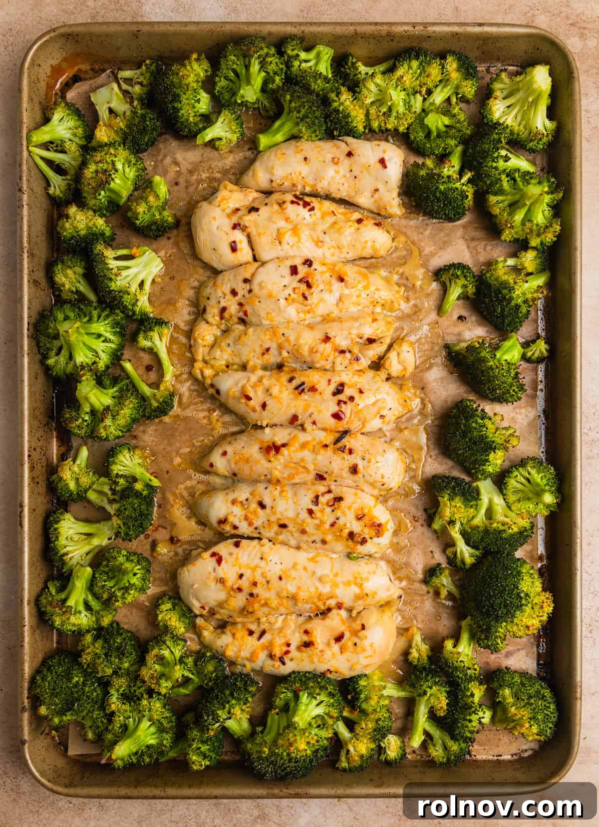 Sticky Orange Chicken One-Pan Dinner 10 Baked orange chicken sheet pan dinner after being baked with cooked broccoli.