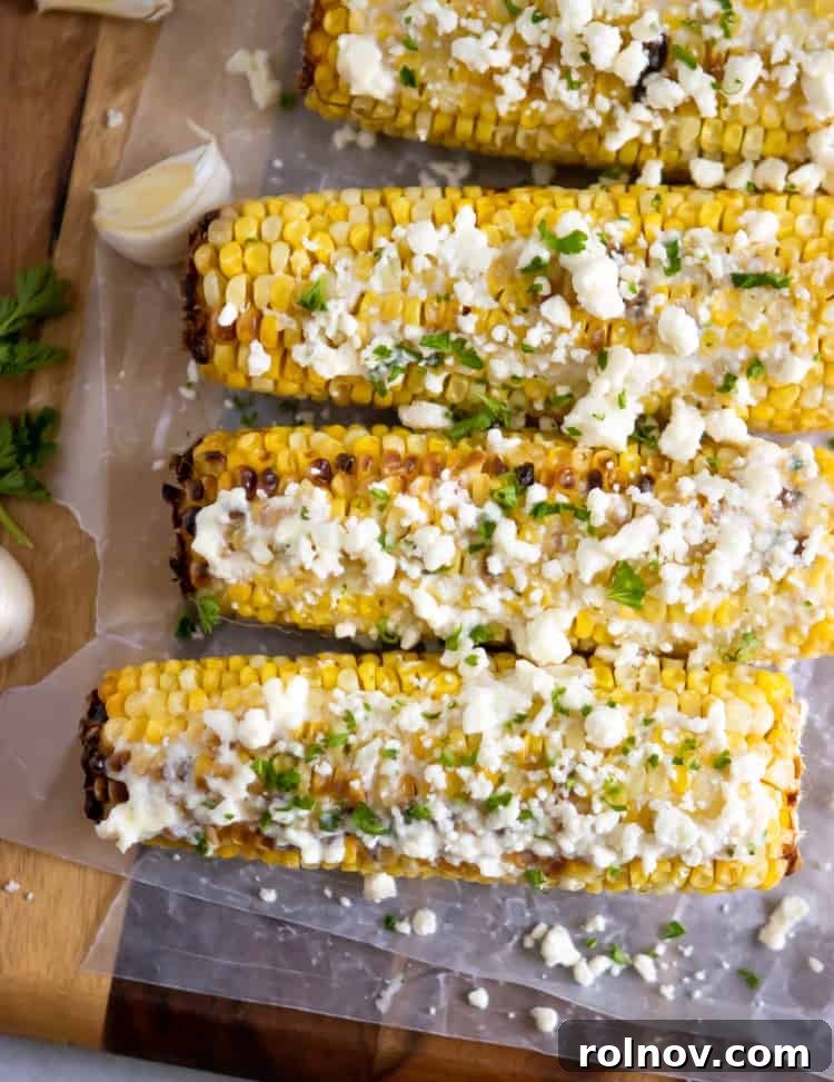 Garlic Feta Buttered Street Corn 4 Close-up of grilled corn on the cob covered in a delectable garlic feta butter and fresh parsley.