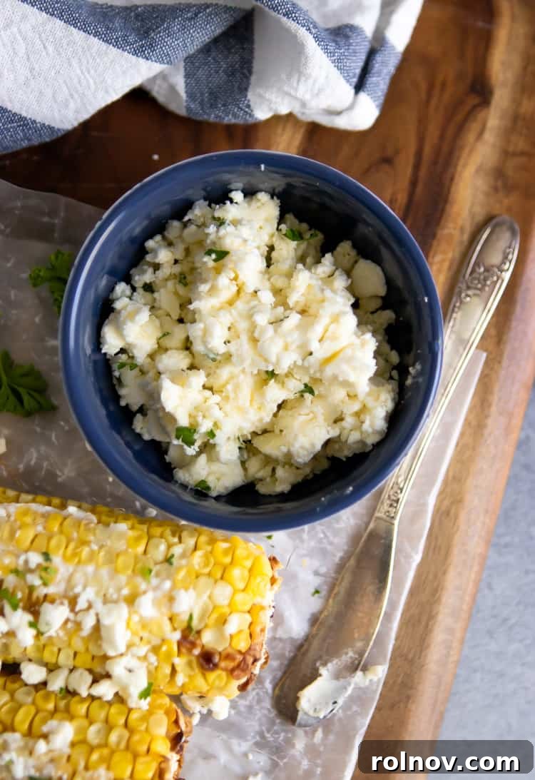 Garlic Feta Buttered Street Corn 5 Four ears of street corn with garlic feta butter on a serving platter, ready for a meal.