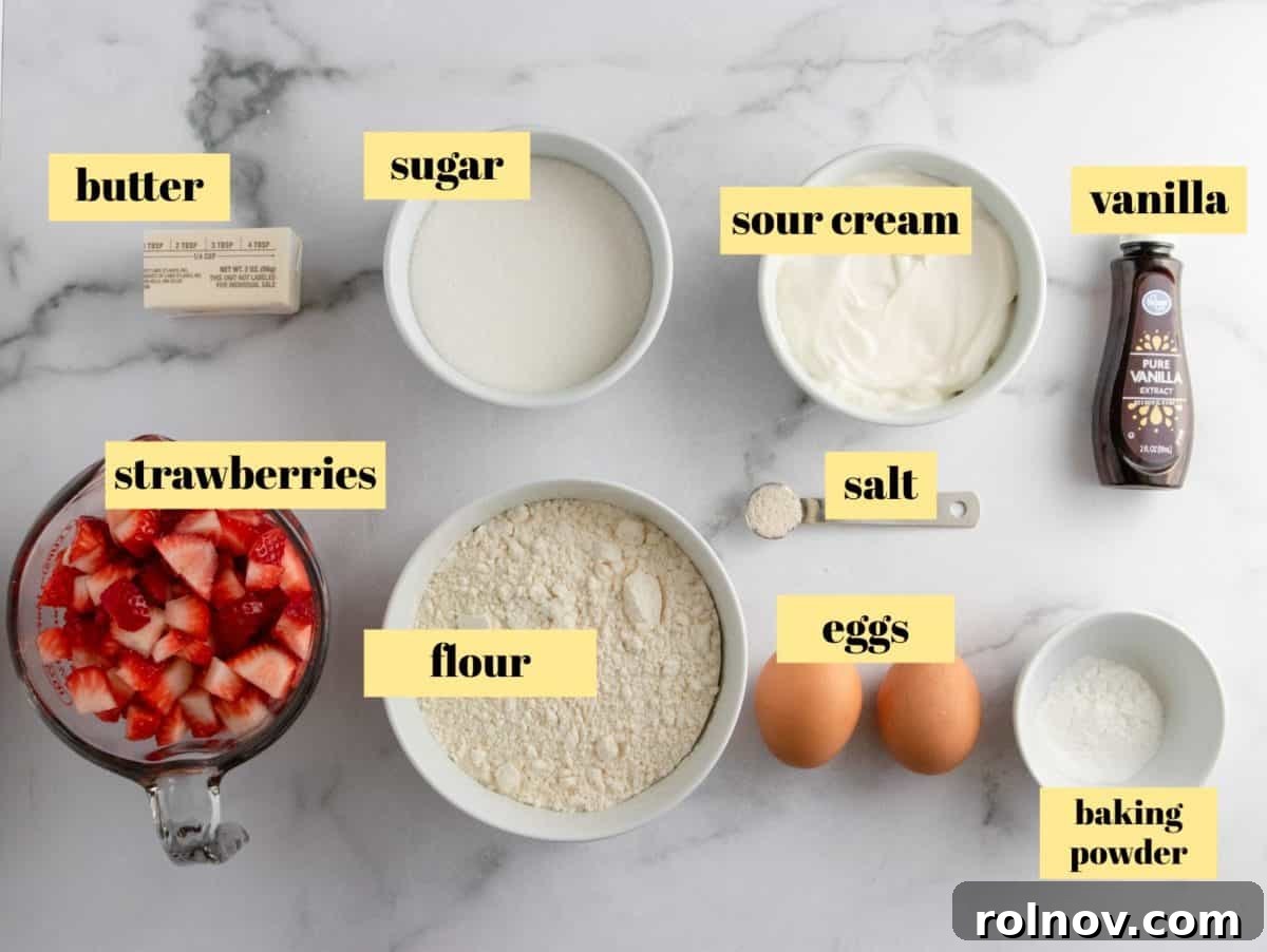 Sweet Strawberry Crumble Muffins 3 Ingredients laid out for making strawberry muffins, including flour, sugar, butter, eggs, sour cream, and fresh strawberries.