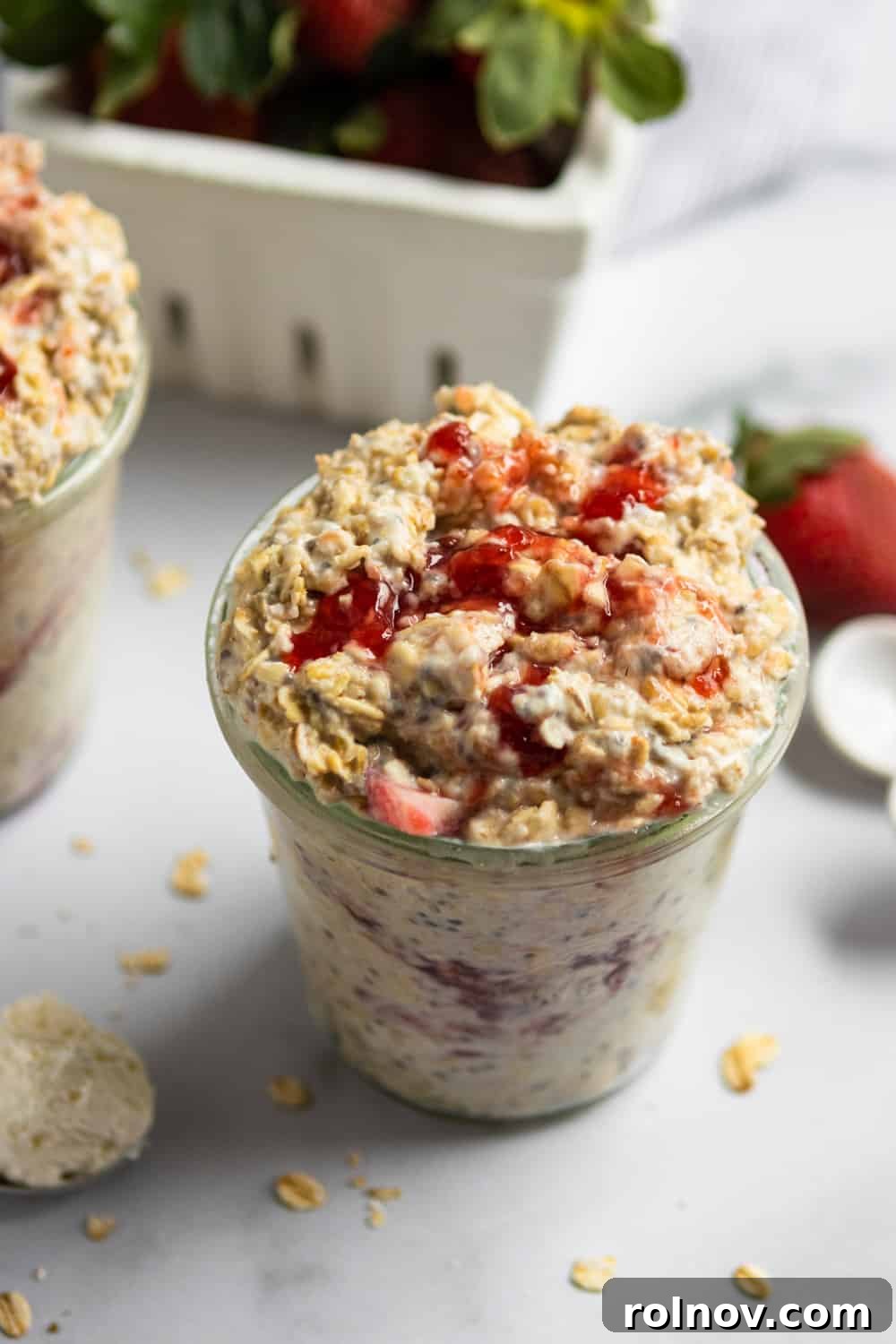 Decadent Strawberry Cheesecake Overnight Oats 4 Overnight oatmeal with strawberries and jam in glass jar.