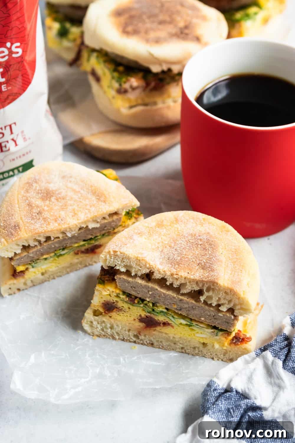 Ready-to-Go Spinach Feta Breakfast Sandwiches 4 Individually wrapped frozen breakfast sandwiches, neatly stacked and ready for freezer storage.