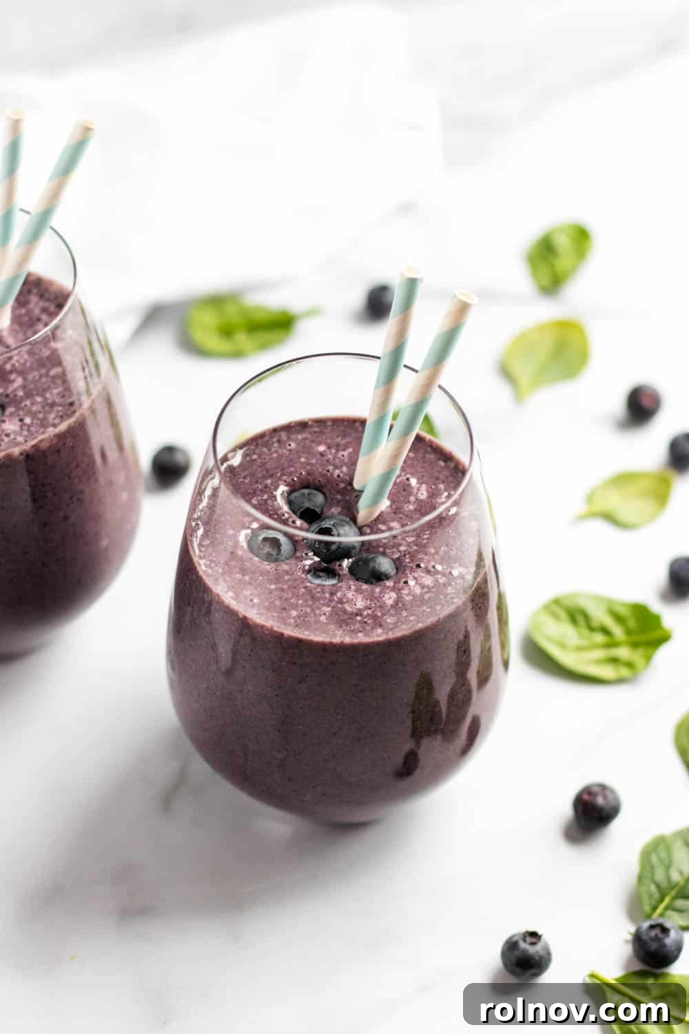 Inflammation-Fighting Blueberry Smoothie 4 All the fresh ingredients for the Anti-Inflammatory Blueberry Smoothie laid out on a clean counter, including frozen banana, blueberries, spinach, almond butter, almond milk, cinnamon, and cayenne pepper.