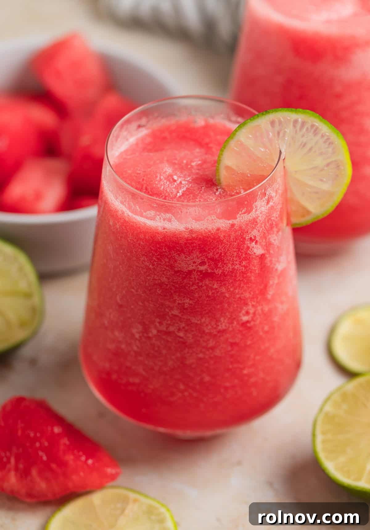 Blushing Watermelon Chill 3 Glass with watermelon frosé and lime slice to garnish.