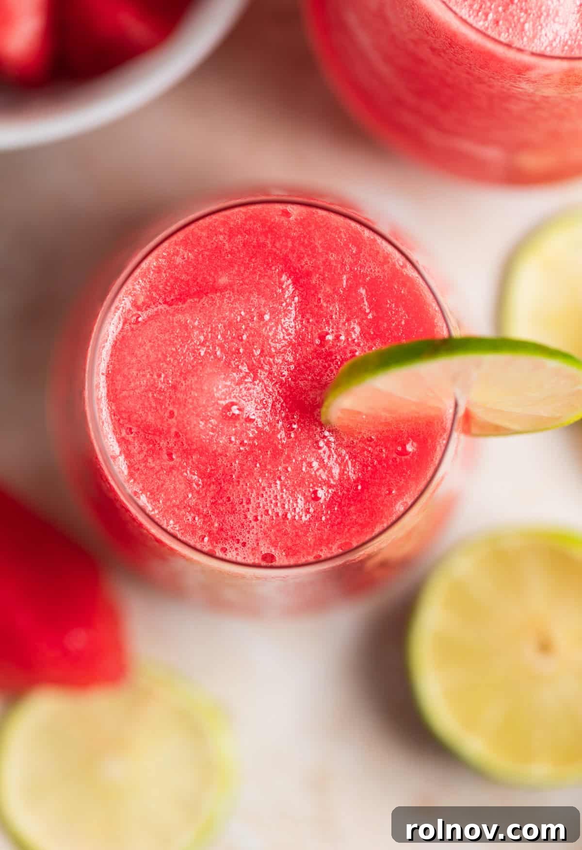 Blushing Watermelon Chill 6 View inside wine glass with frozen watermelon rosé with a lime slice for garnish.