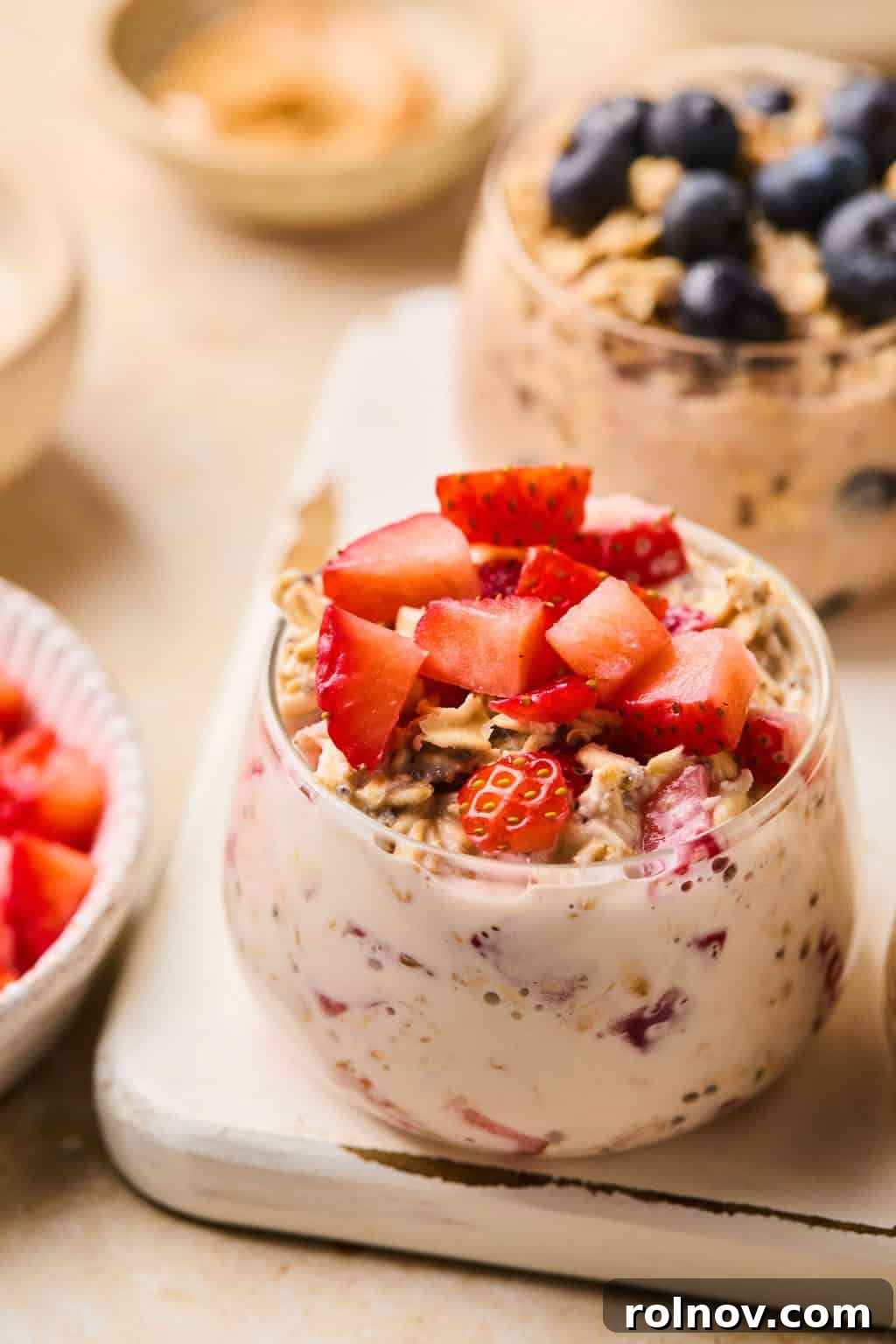 6 Simple Overnight Oats to Master Your Mornings 12 Prepared strawberries and cream oats in bowl with diced strawberries.