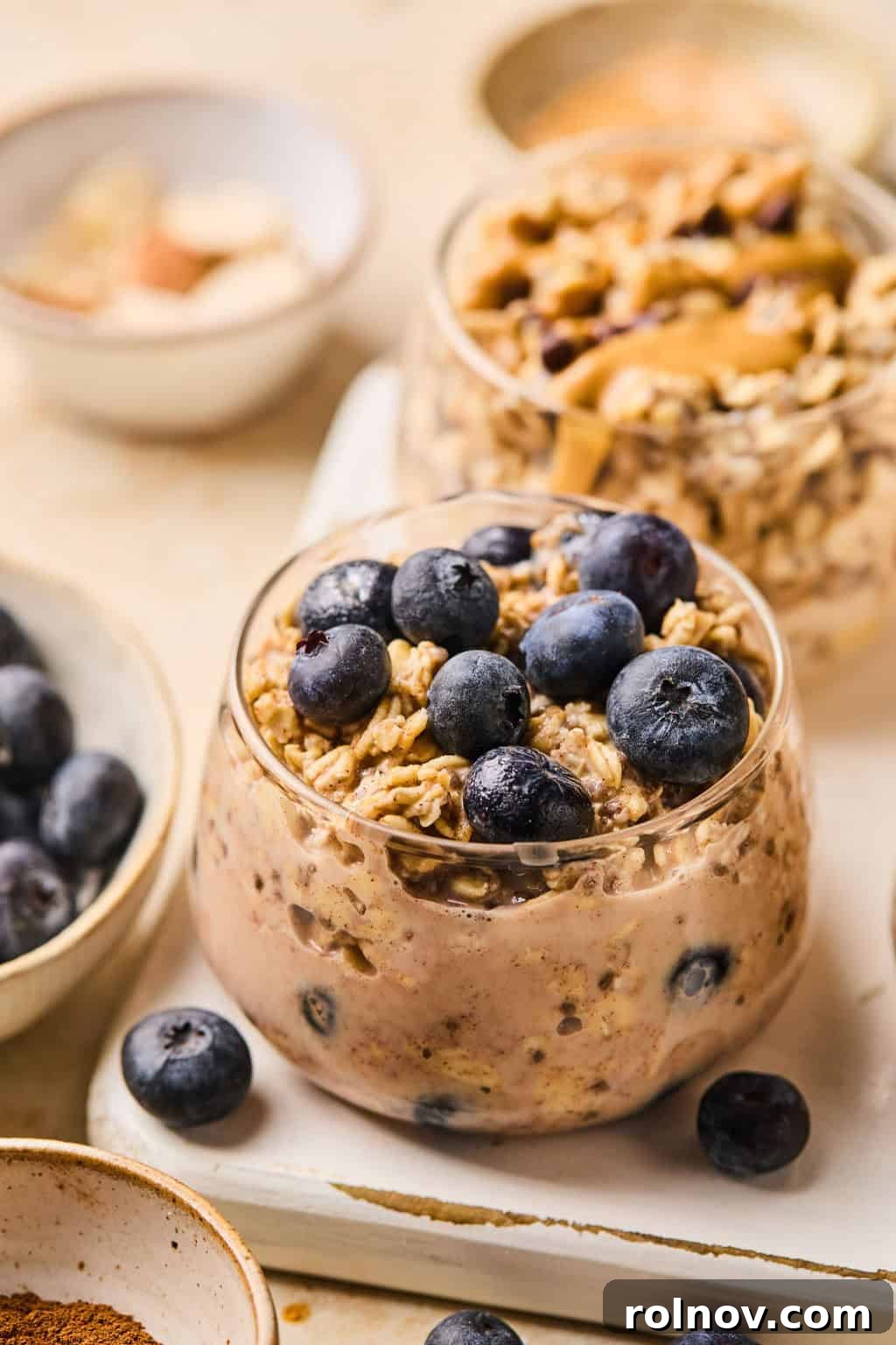6 Simple Overnight Oats to Master Your Mornings 8 Blueberry muffin oatmeal prepared in glass jar topped with berries.