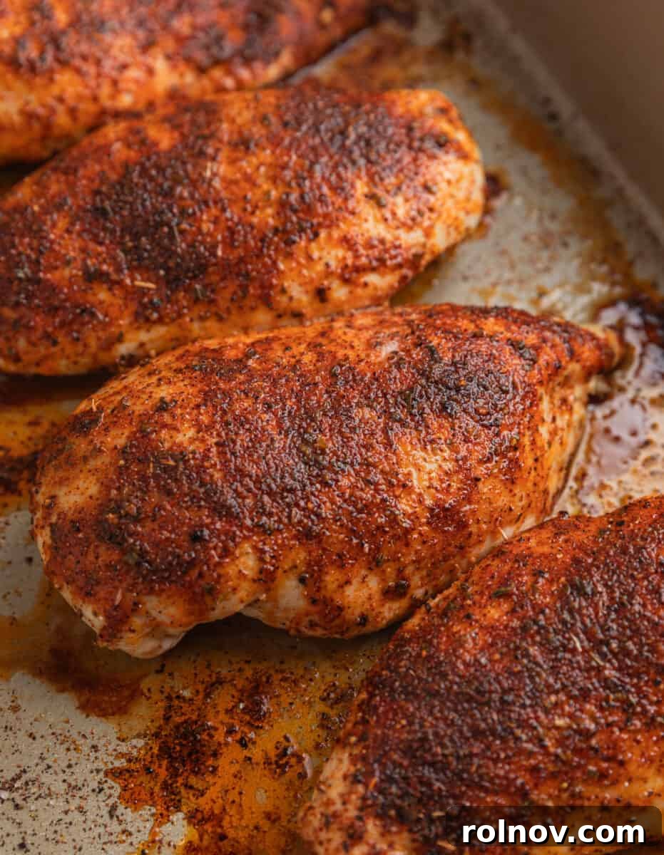 Tropical Mango Chicken 5 Golden-brown, perfectly baked seasoned chicken breasts resting in a baking pan after cooking.