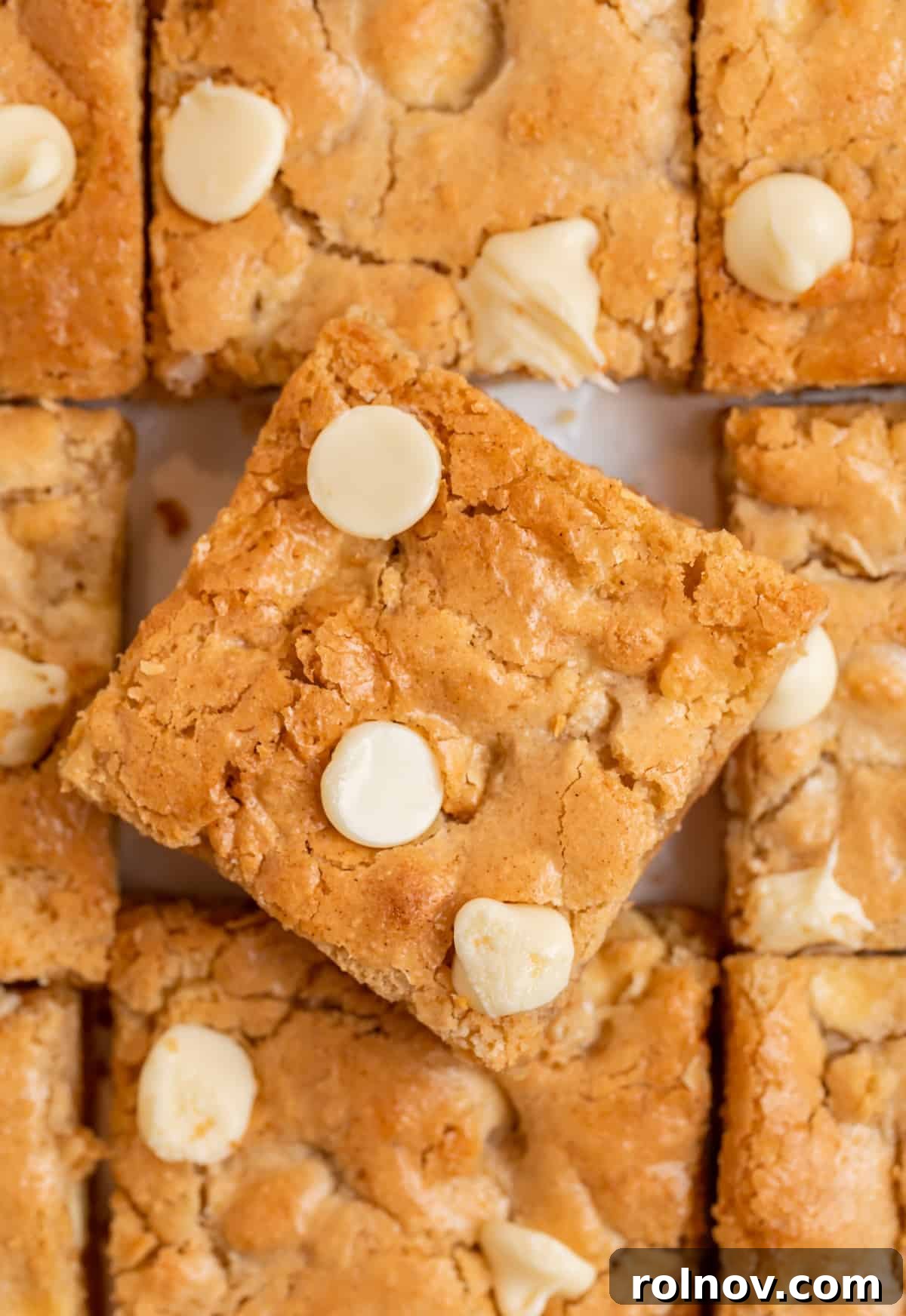 Delicious gluten-free almond flour blondies with rich white chocolate chips, arranged artfully with one slice slightly tilted.