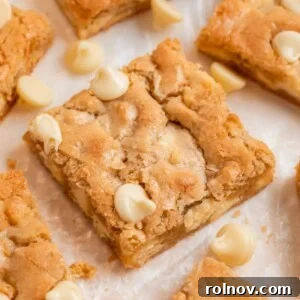 Almond flour blondies on parchment with white chocolate chips.