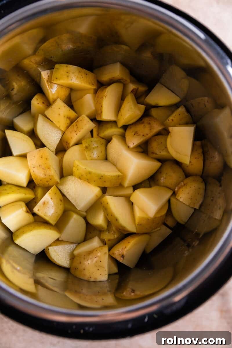 Creamy Instant Pot Garlic Parmesan Mashed Potatoes 4 Cubed gold Yukon potatoes in Instant Pot.