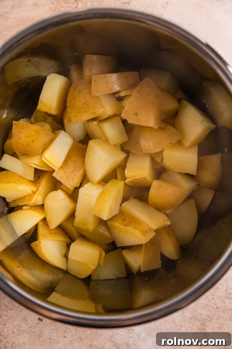 Creamy Instant Pot Garlic Parmesan Mashed Potatoes 5 Potatoes in pressure cooker after cooking.