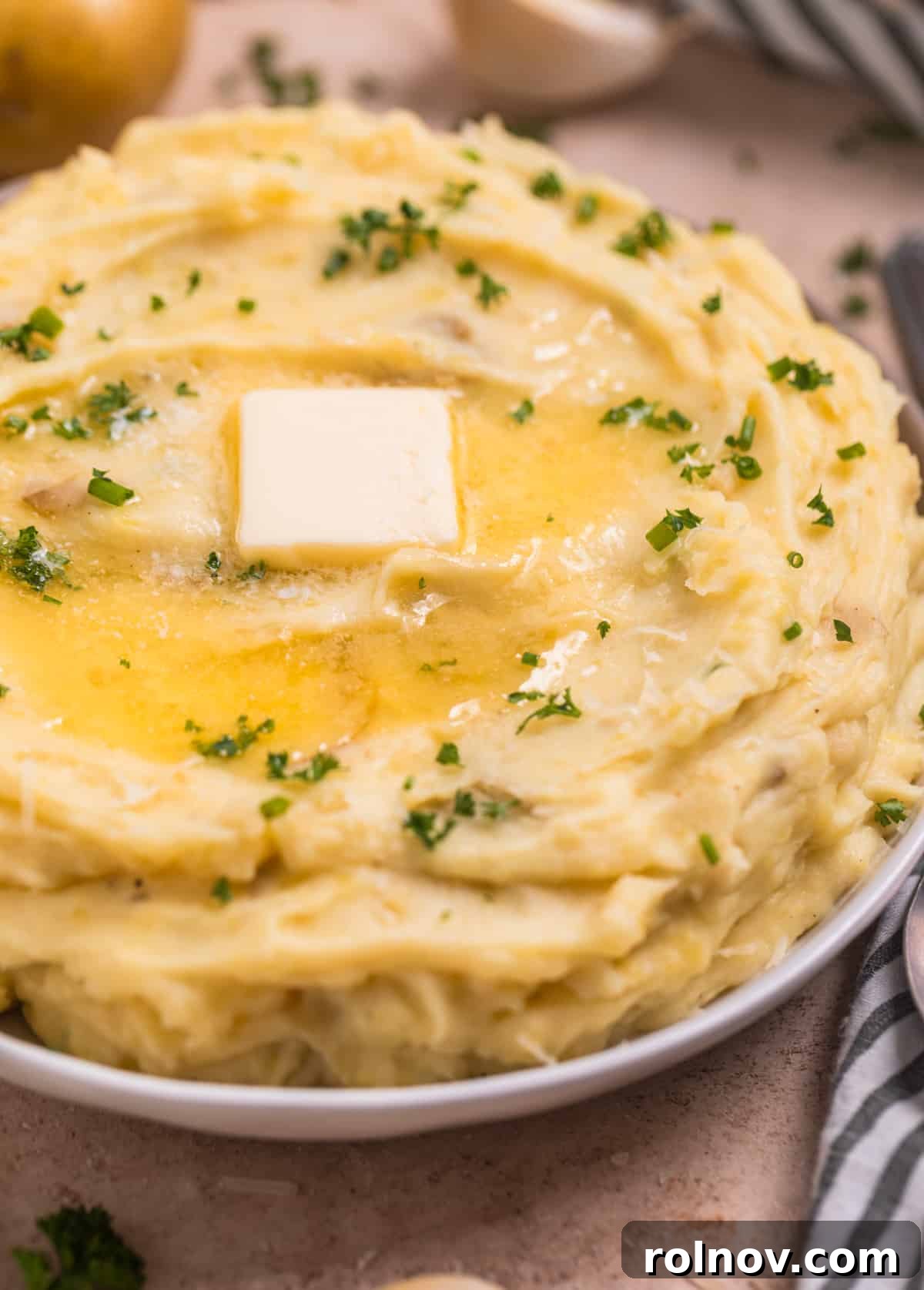 Creamy Instant Pot Garlic Parmesan Mashed Potatoes 7 Melted butter on top of Instant Pot garlic parmesan mashed potatoes.