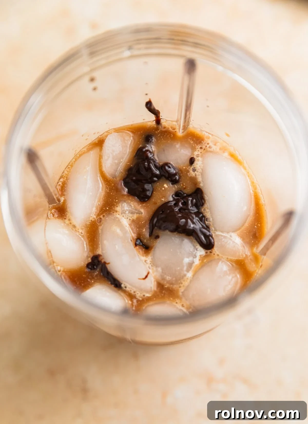 Decadent Homemade Mocha Frappuccino 4 Ice, coffee, chocolate sauce, and milk are in the blender, before the blending process begins.